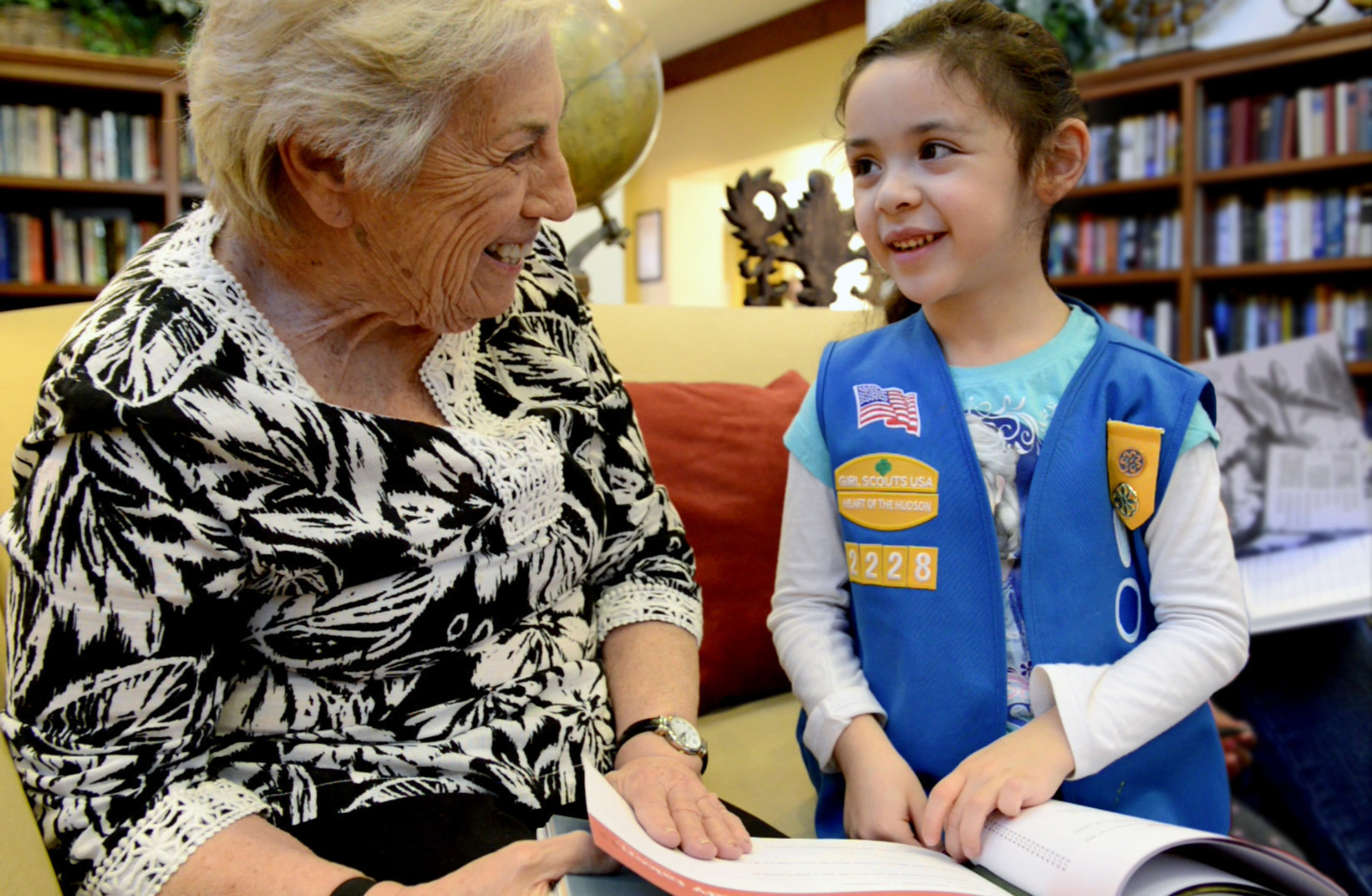 Atria resident and Girl Scout enjoy bonding over Atria Senior Living's Field Notes from an Adventurous Life: A Guided Journal.  The 130-page hardcover, award-winning journal provides a unique way for people to share their life stories and inspire future goals and aspirations. It was designed using vintage imagery, quotes and event-specific prompts to inspire interest and create conversation between multiple generations. Each of Atria's 21,000 residents have received a gift copy and a selection of youth groups, schools, staff and family members will be journaling along with residents across the country.
