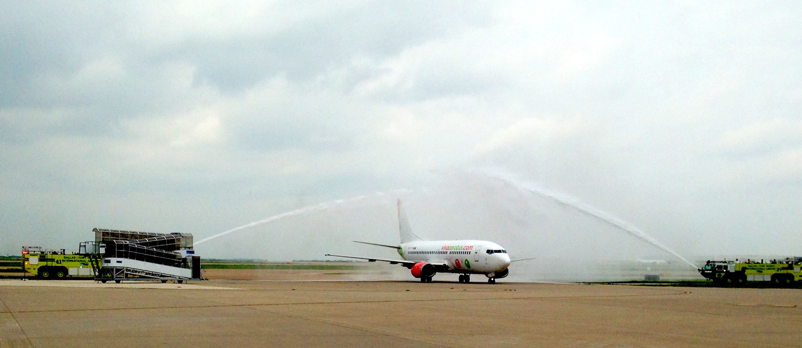 A Viva Aerobus 737 arrives at Dallas/Fort Worth International Airport to a water cannon "shower of affection" salute, as the carrier begins service at DFW.