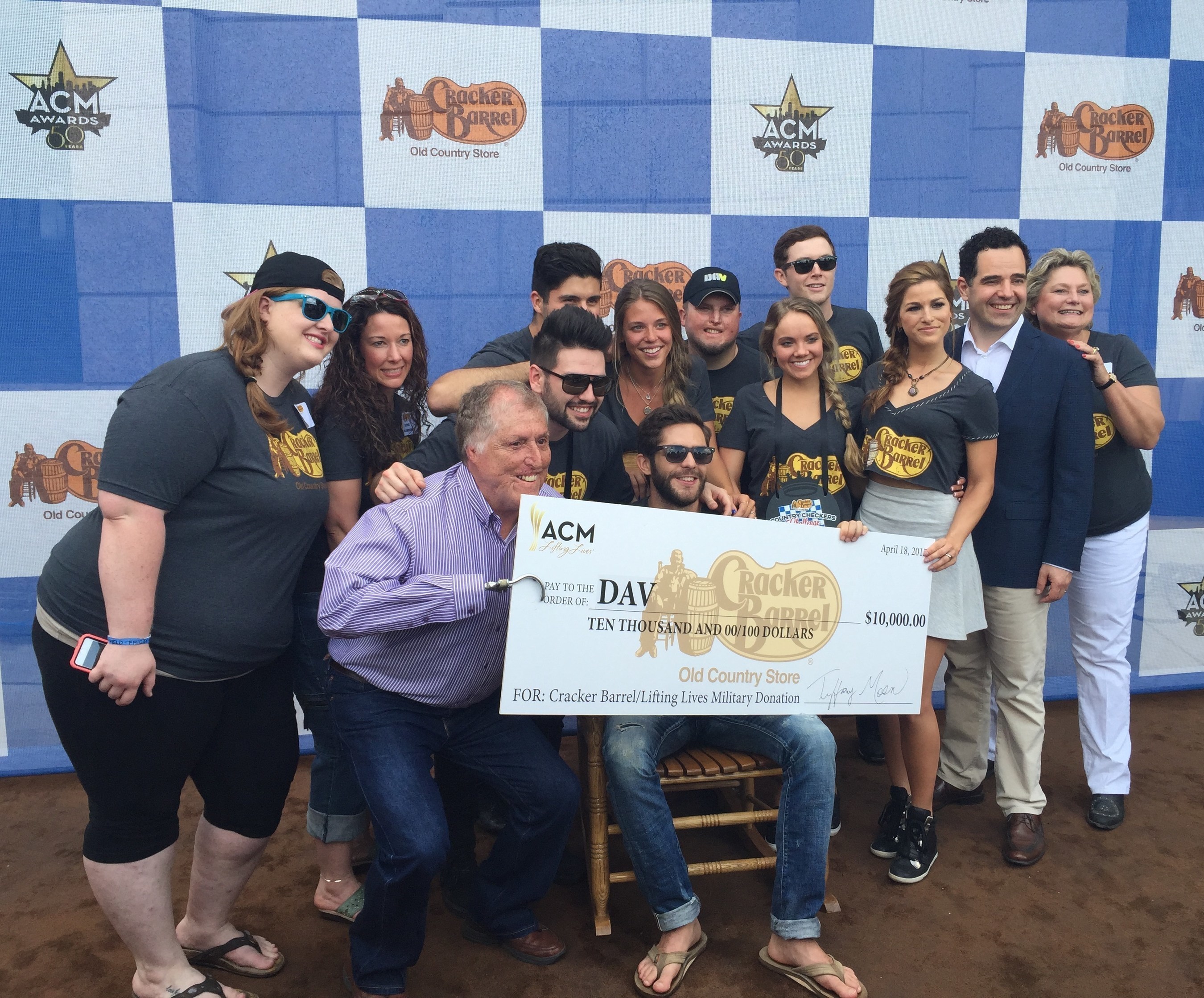 Former DAV National Commander, Bobby Barrera (front left), poses with Team Thomas Rhett and Chris Ciavarra, senior vice president of marketing for Cracker Barrel Old Country Store (second row, second from right) after the Cracker Barrel Old Country Store Country Checkers Challenge at the 3rd Annual ACM Party for a Cause Festival.
