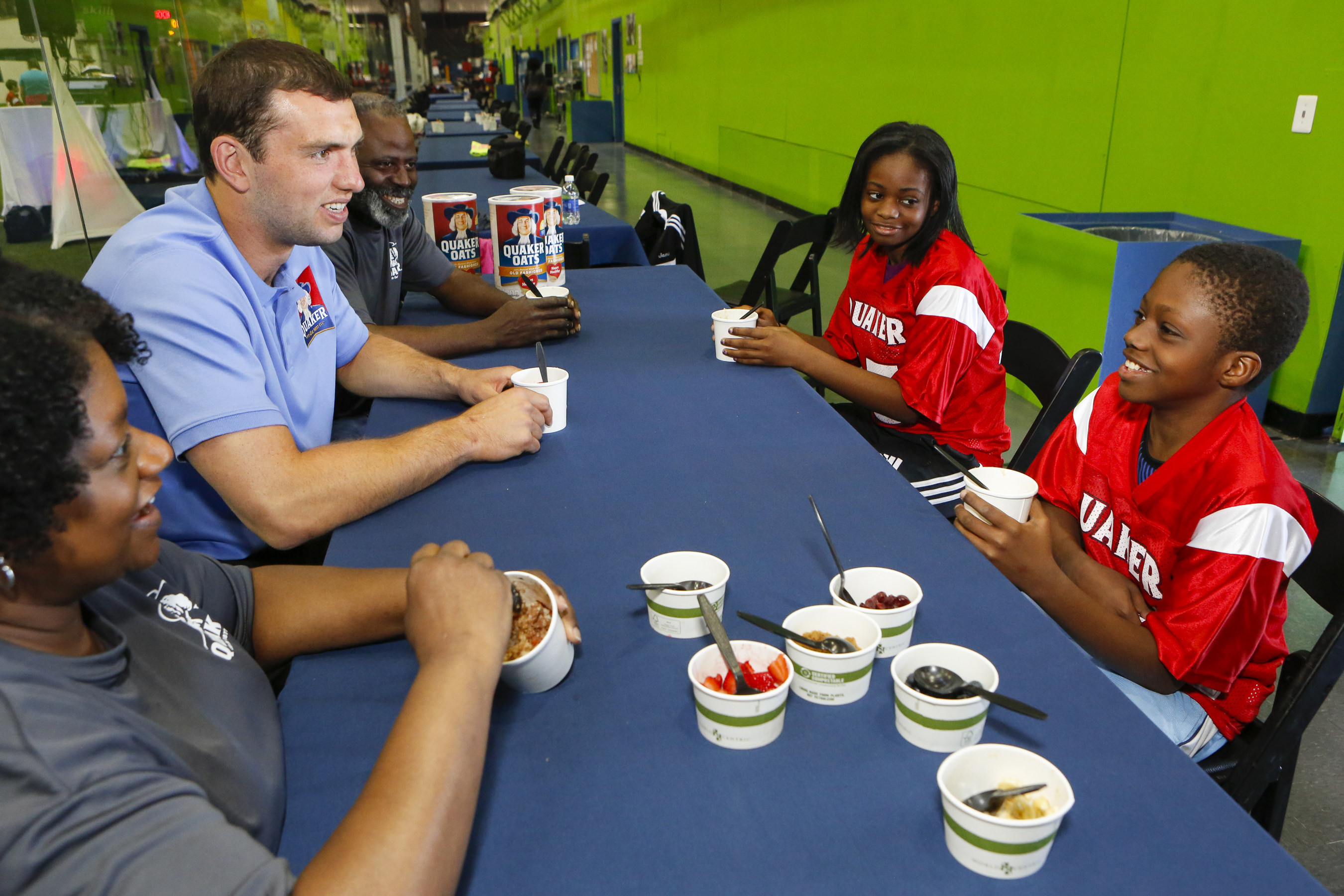 Indianapolis Colts quarterback Andrew Luck, second from left, enjoys an oatmeal breakfast with a local Philadelphia family, the Loftons, winners of the national Quaker "Make the Play" contest aimed at inspiring families to get out and play together on Saturday, April 18, 2015, in Hatboro, Pa.