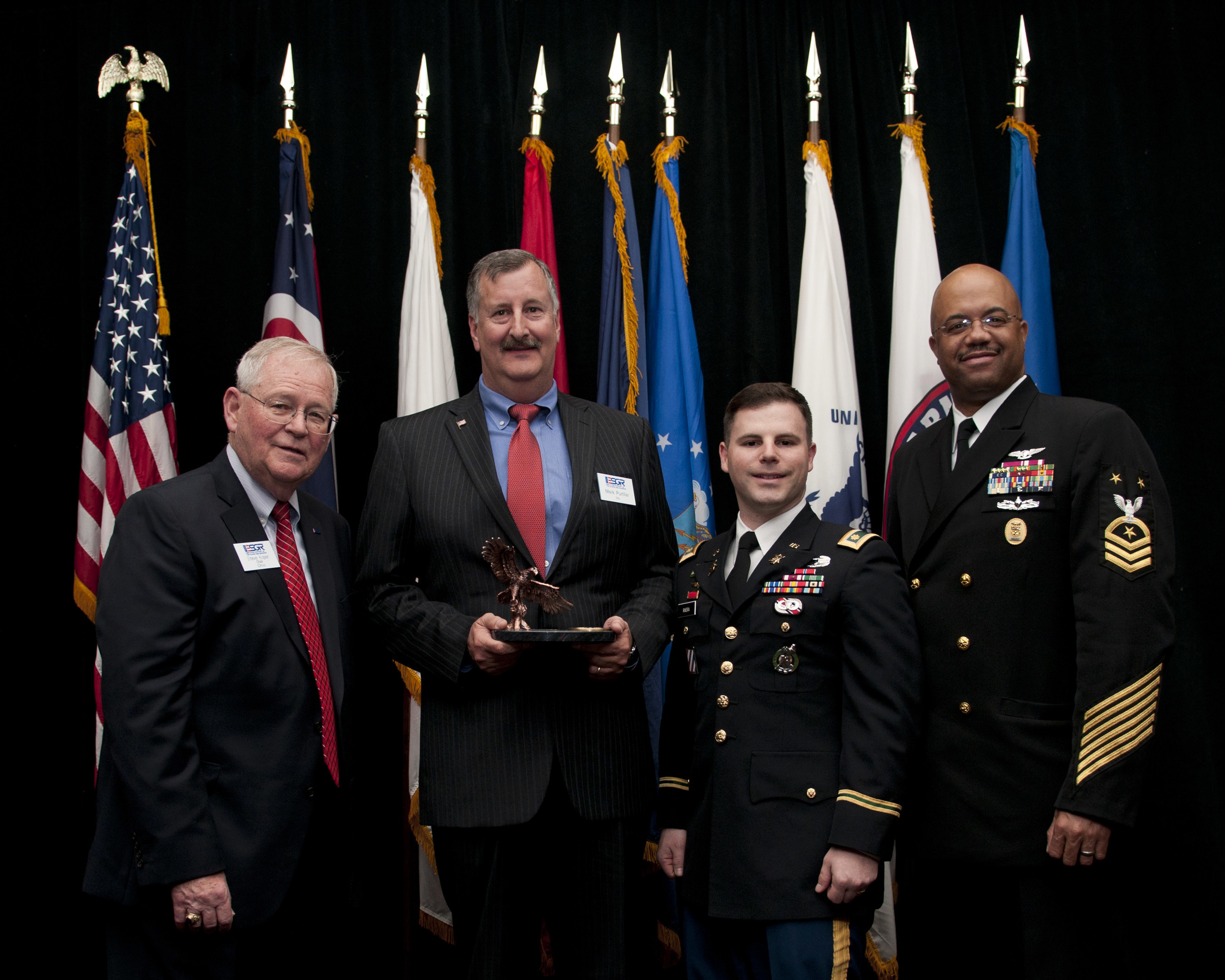 The Ohio Committee for Employer Support of the Guard and Reserve has honored The Goodyear Tire & Rubber Company with the Pro Patria Award. Shown with the award (from left) are: Retired Air Force Brig. Gen. Stephen Koper; Mark Purtilar, vice president and Chief Procurement Officer of The Goodyear Tire & Rubber Company; Veteran and Supplier Qualification Project Leader Jose Rivera; and Force Master Chief C.J. Mitchell, U.S. Navy Reserve.