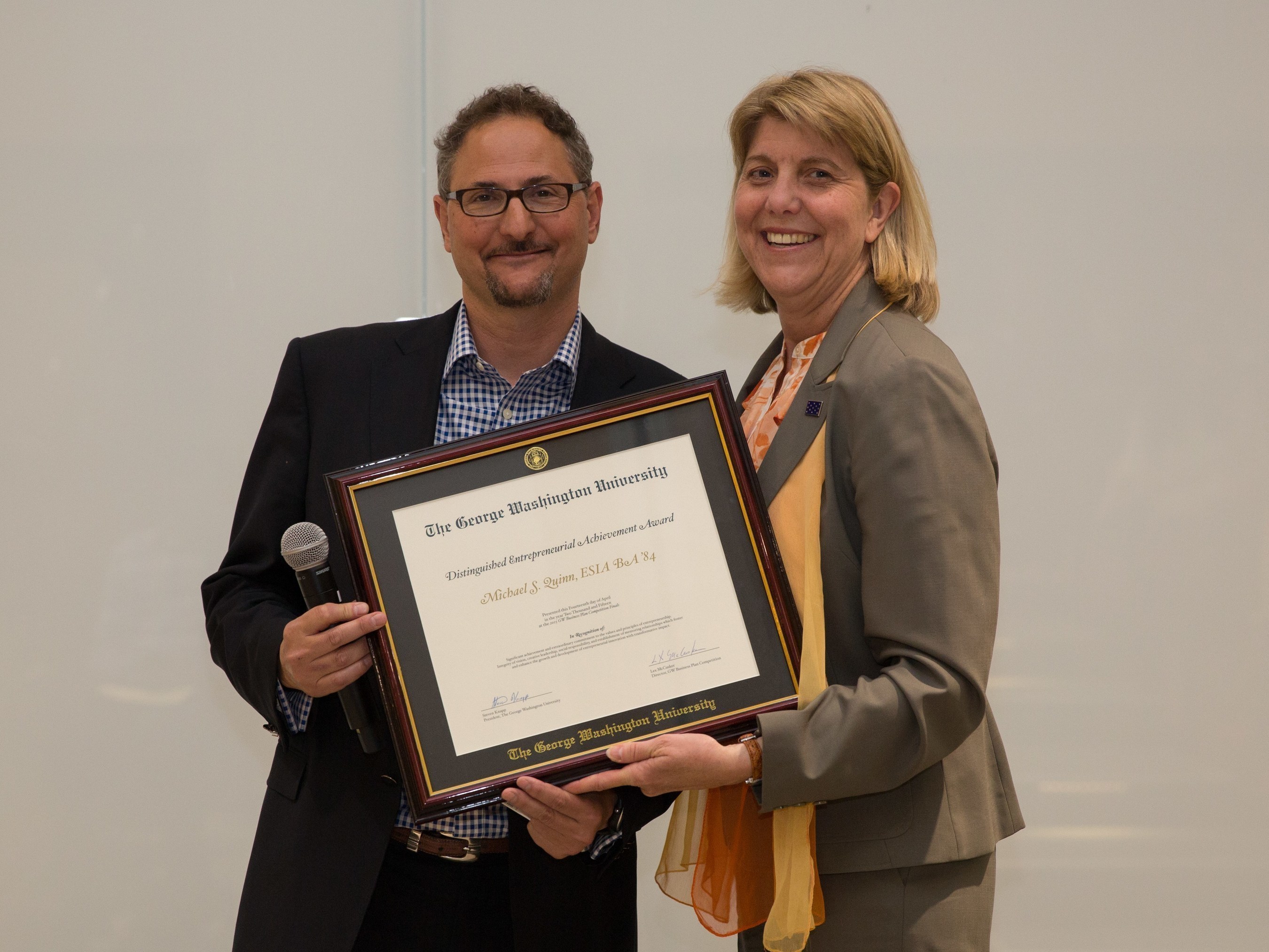 Michael Quinn, Q Advisors Partner, Receives Distinguished Entrepreneurial Achievement Award from Linda Livingstone, Dean of the GW Business School
