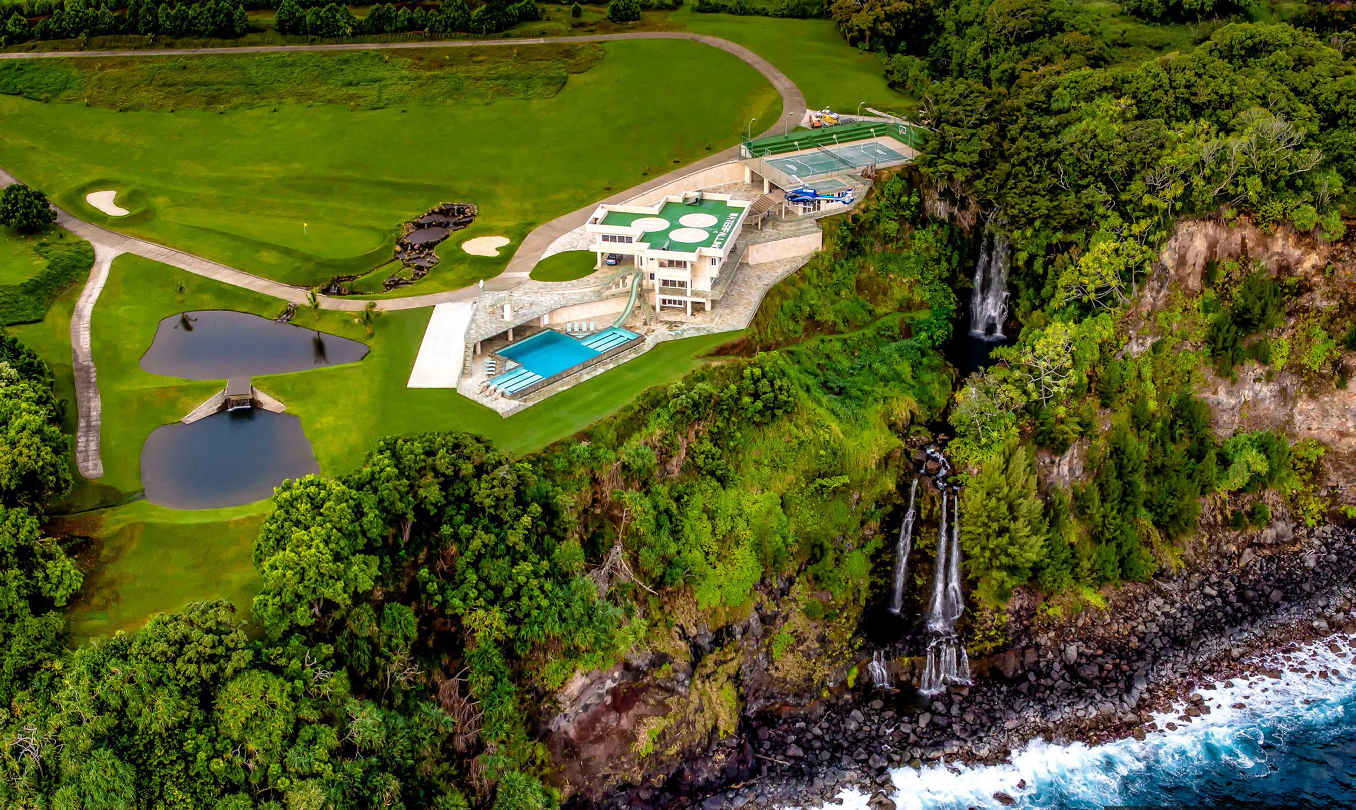 Hawaii's epic Waterfalling Estate features twin natural waterfalls, an olympic infinity pool, and tri-level ocean bluff compound.
