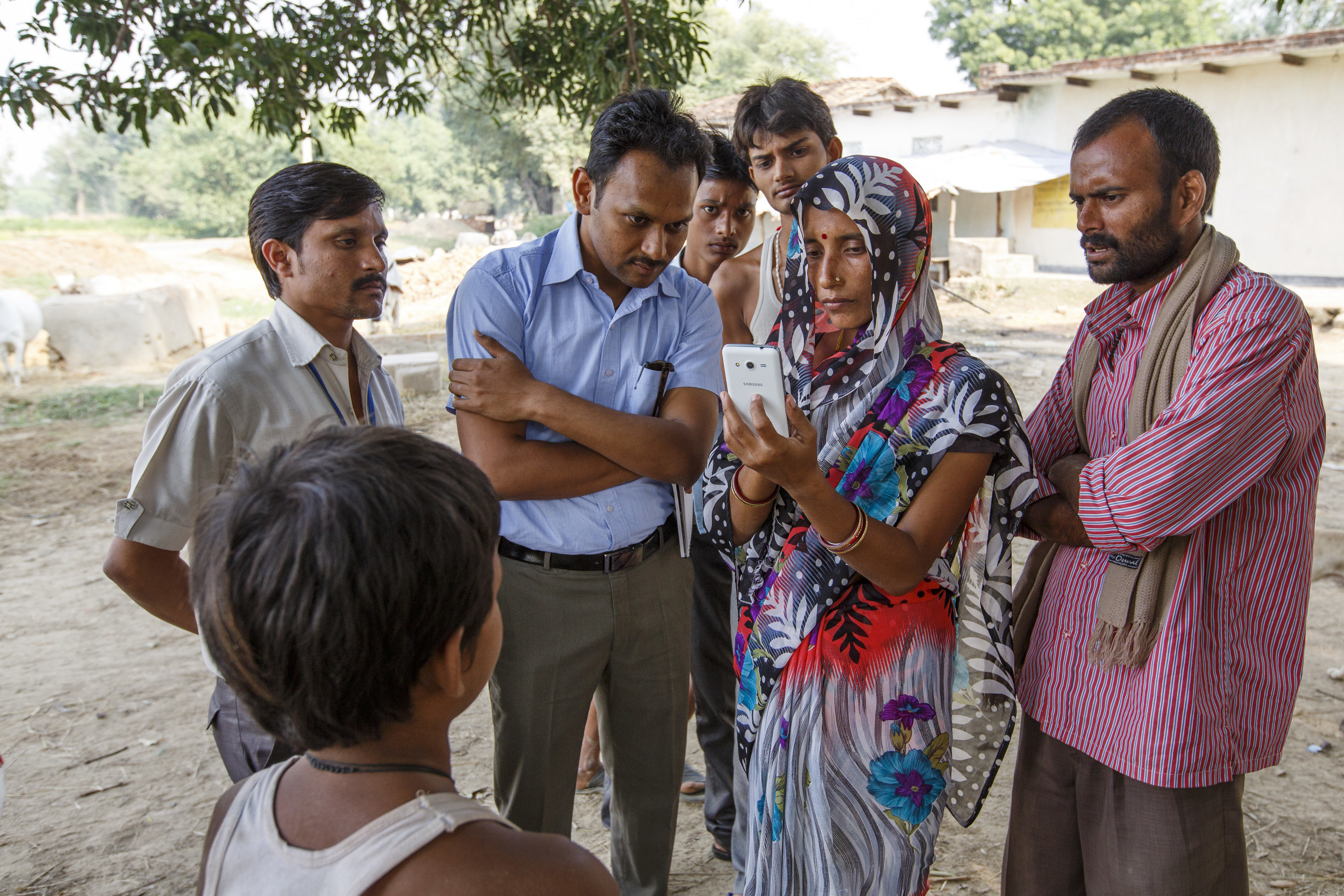 HelpMeSee staff and partners train a community health worker on the GIS-GPS app near Chitrakoot, India.