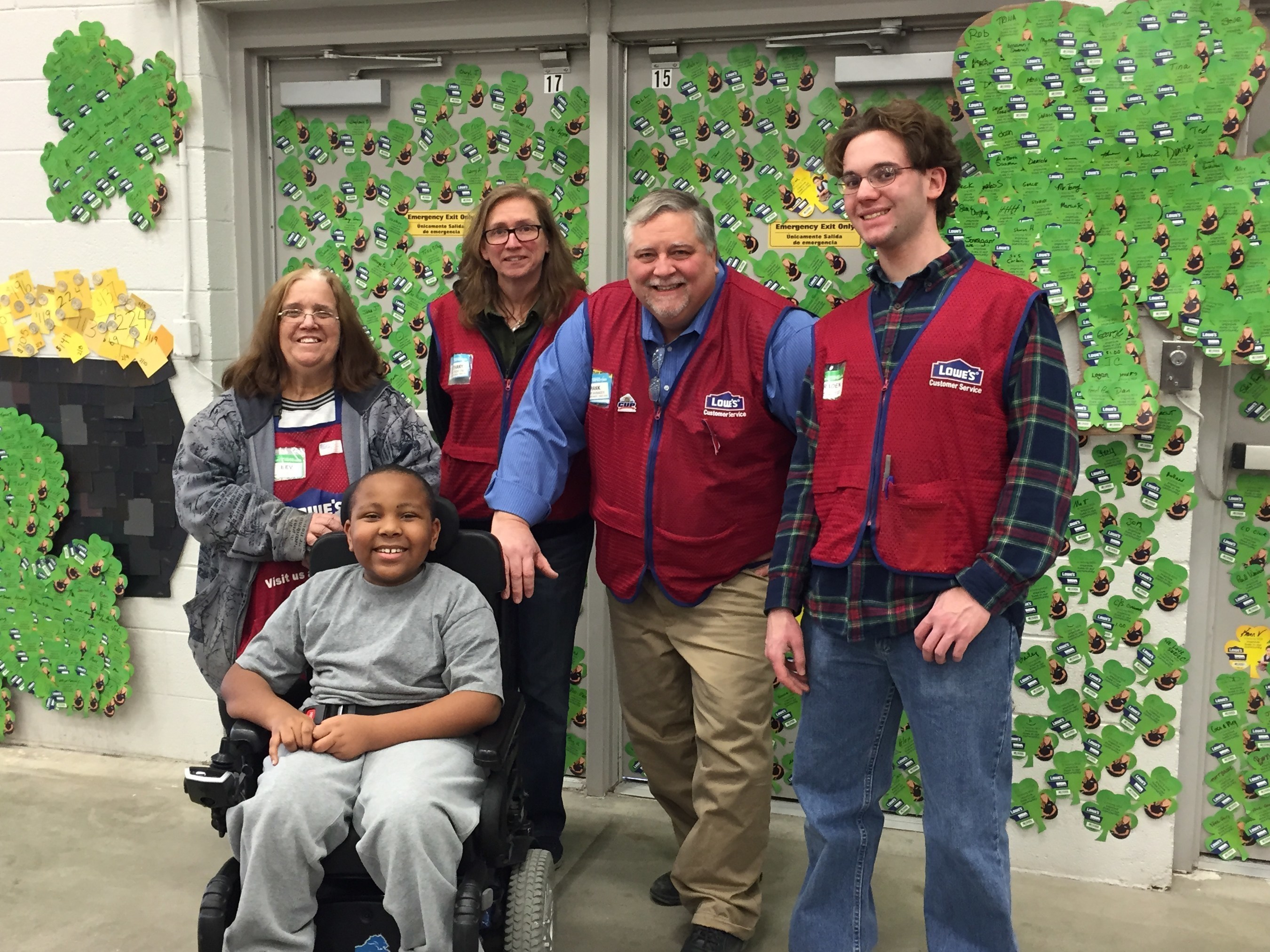 MDA Ambassador Torrance Johnson poses with employees from Lowe's store 734 in Ypsilanti, Mich. in front of their special MDA Shamrock display. Shamrocks bought at checkout during the program were also creatively showcased on the walls of many other Lowe's stores across the country.