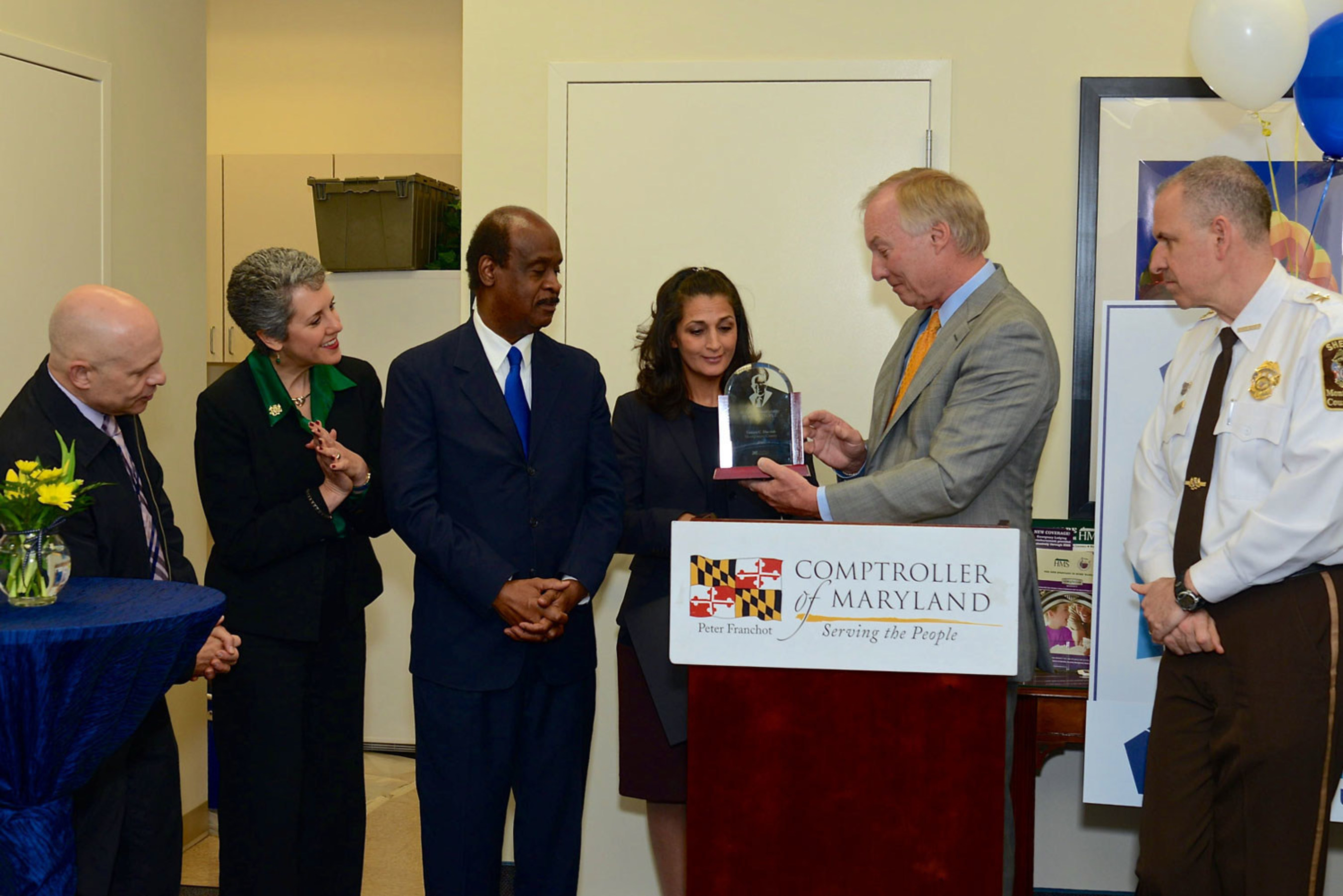 Maryland Comptroller, Peter Franchot presents the 2015 William Donald Schaefer Helping People Award to Tammy Darvish. Looking on from left to right are Jeffery Slavin, Mayor of Sommerset, MD, Maryland State Senator, Cheryl Kagan, Montgomery County Executive, Ike Leggett and far right, Montgomery County Sheriff, Darren Popkin