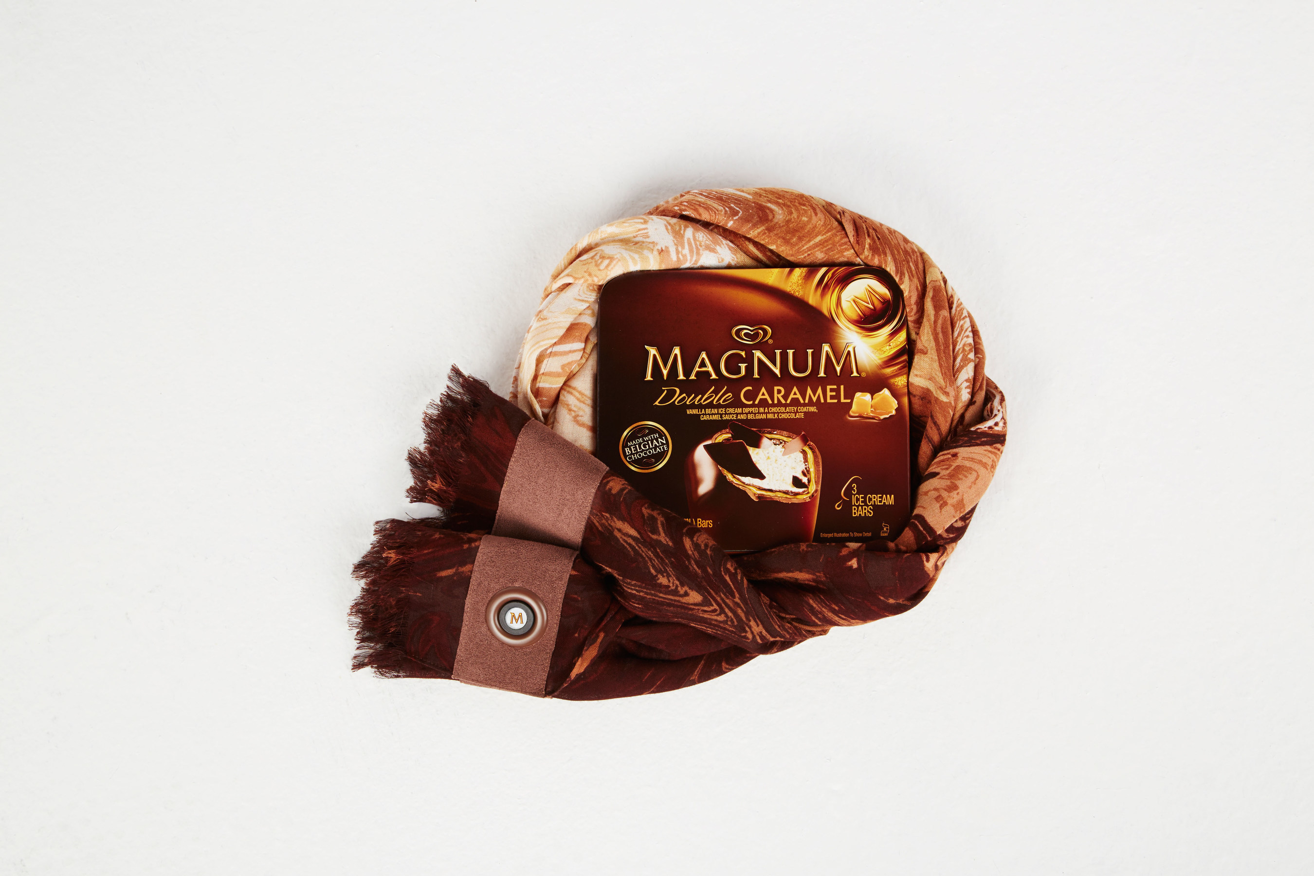 The BCBGMAXAZRIA for MAGNUM Belgian Chocolate Wrap, an innovative accessory infused with an aroma inspired by MAGNUM Belgian Chocolate. The wrap will be available as a limited edition 'gift with purchase' in select BCBGMAXAZRIA stores nationwide this summer.