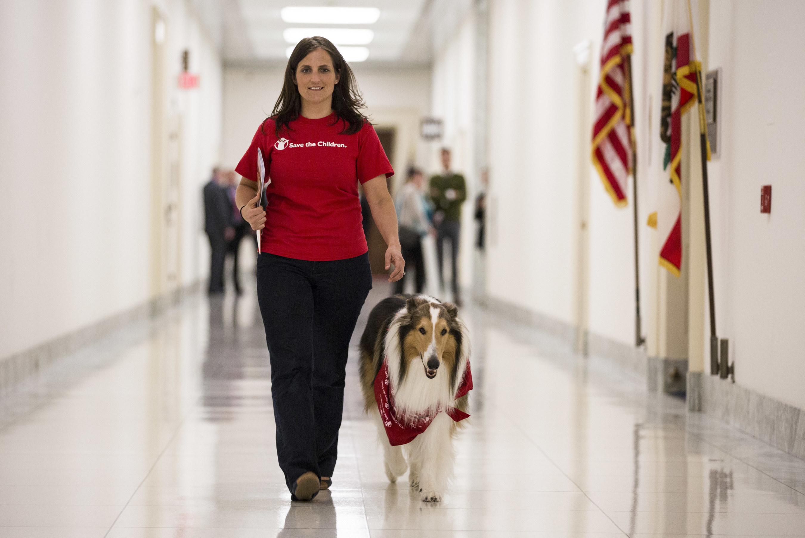 Lassie, Save the Children's animal ambassador for emergency preparedness, walks through the halls Congress with Save the Children's Erin Bradshaw on her way to help lead a Wednesday Congressional briefing on Capitol Hill in Washington, DC, on April 29, 2015.