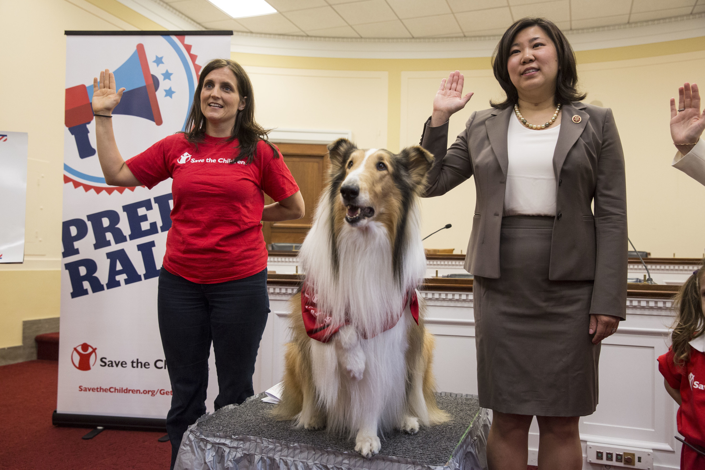 Lassie, Save the Children's animal ambassador, joins Rep. Grace Meng (D-NY) and Save the Children's Erin Bradshaw in leading a pledge to protect children from disaster at a Wednesday Congressional briefing on Capitol Hill in Washington, DC, on April 29, 2015.