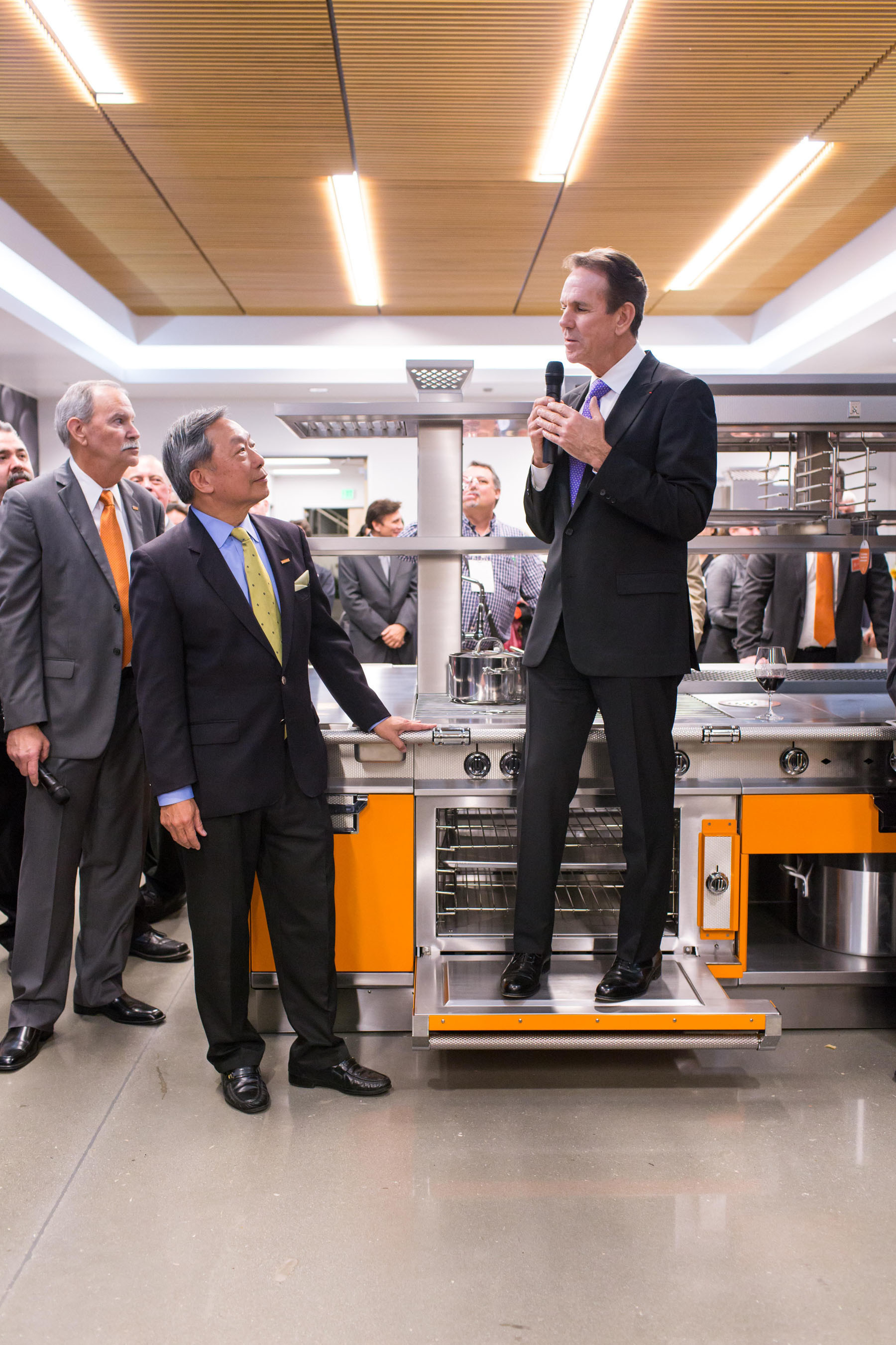 Chef Thomas Keller makes a toast to Stanley Cheng while testing the strength of the latest Hestan Commercial island suite.