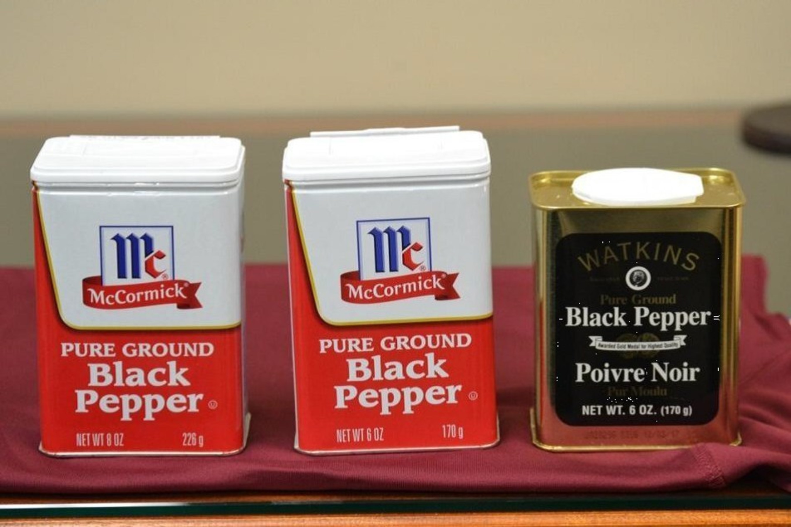 The McCormick Large Tins with an 8-ounce fill (on the left) was marketed for decades. McCormick's use of the same McCormick Large Tin with a 6-ounce fill with nonfunctional slack-fill (in the middle) gives the false and misleading impression that there is more ground pepper in the tin than in the Watkins Tin (on the right) which also has six ounces of ground black pepper.
