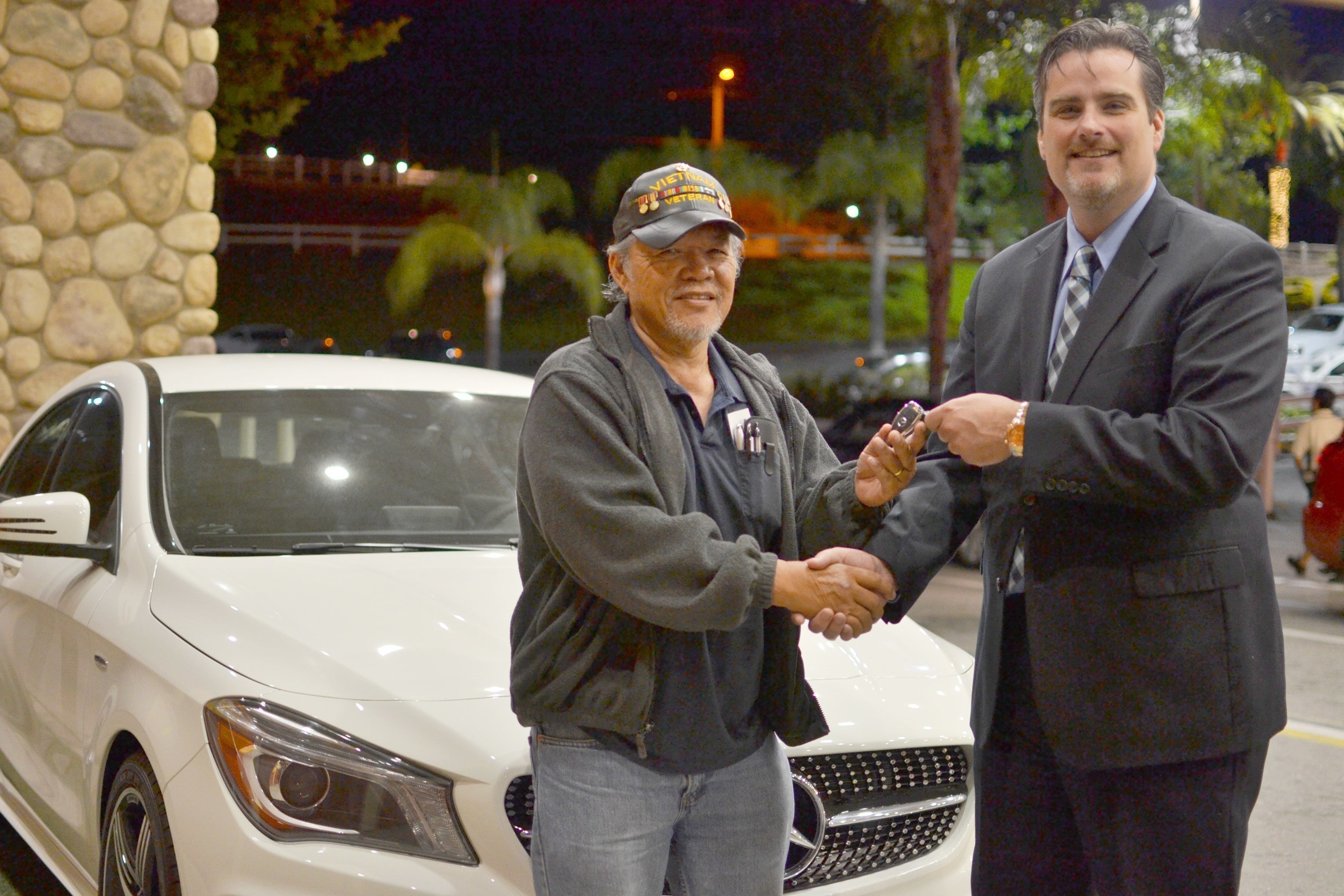 Soboba Casino's Director of Marketing Michael J. Broderick proudly hands the keys of a brand new Mercedes to Vietnam veteran Francis Abergas.