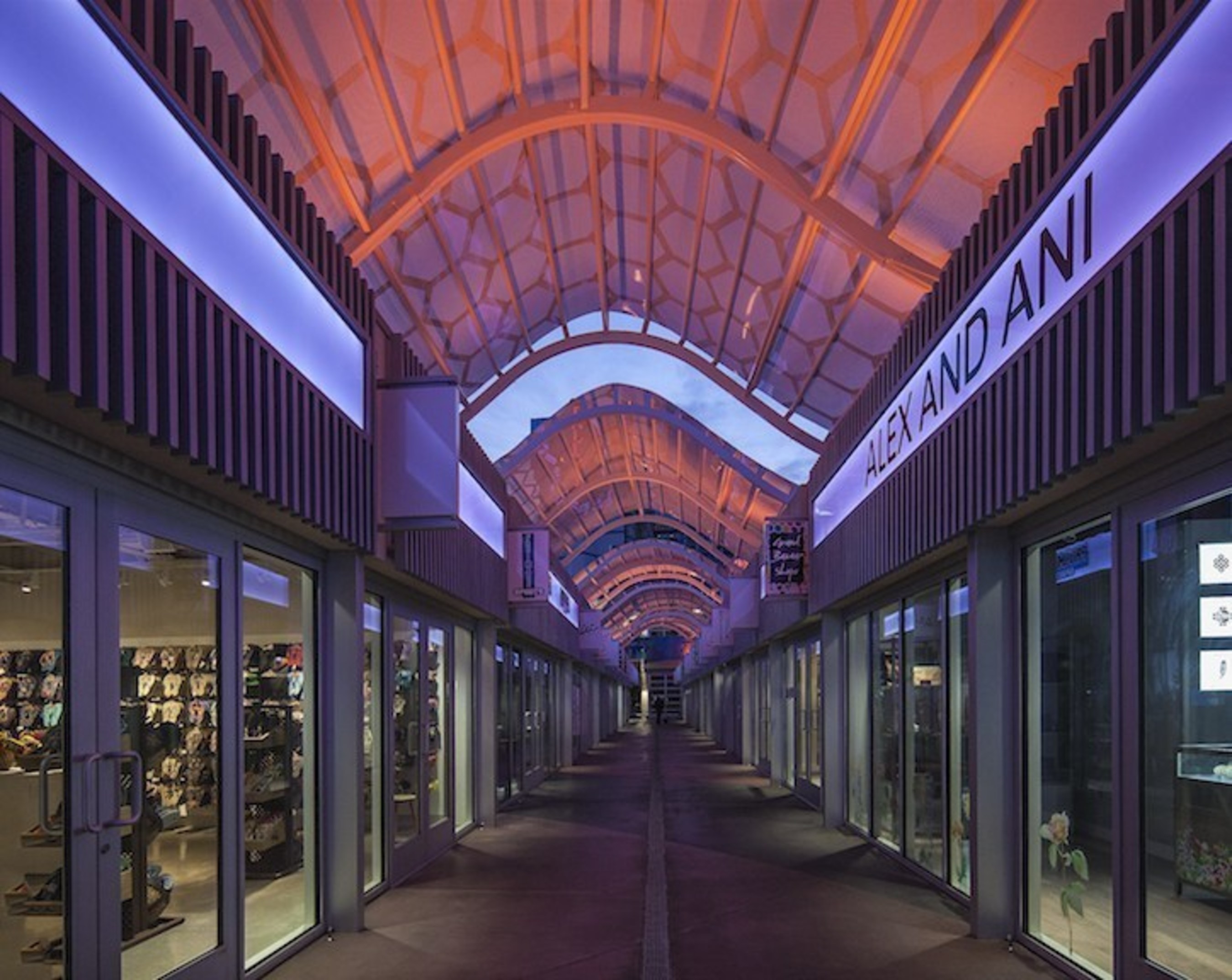 Undulating facades and canopies are skinned in multi-colored scales that deliver vibrant and eye-catching scenes during the day and especially at night when illuminated by hundreds of programmable LED fixtures.