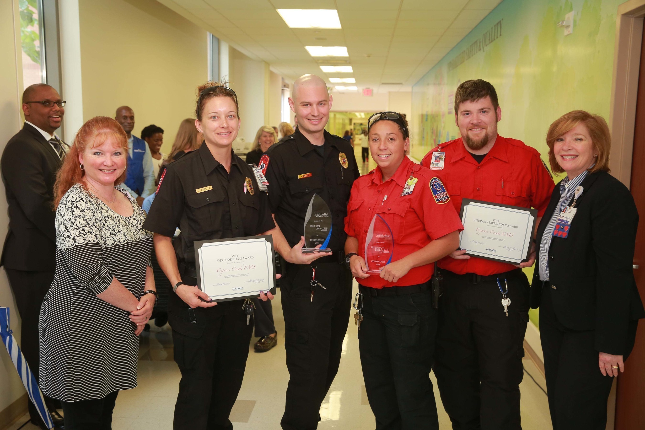 Members of Cypress Creek EMS receive the EMS Code STEMI and the Khurana EMS Stroke awards from Houston Methodist Willowbrook Hospital executives during National EMS Week.