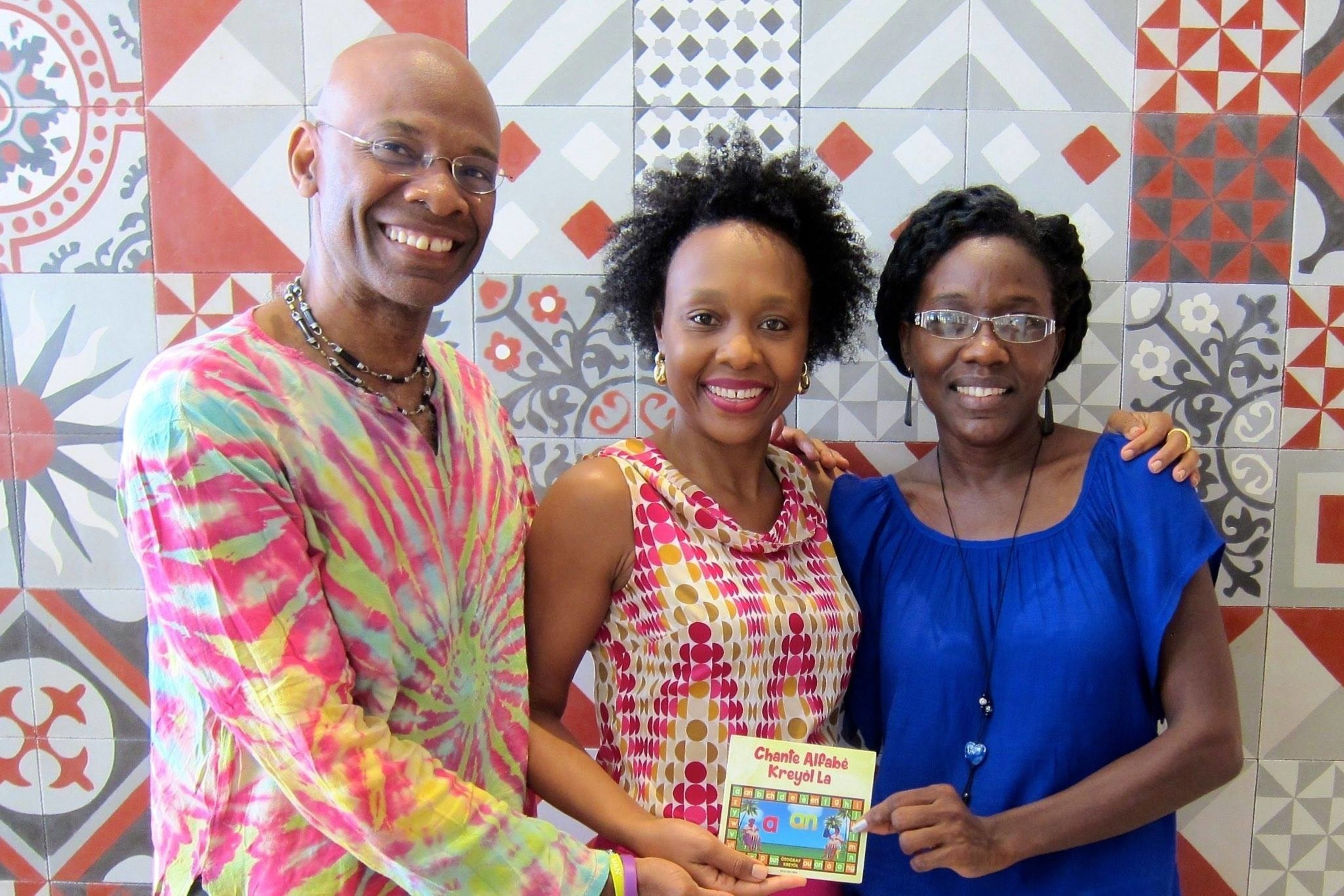 Professor Michel DeGraff, Marie Rodny Laurent and Ann Timothee Milfort Holding the newly released DVD of the kreyol alphabet