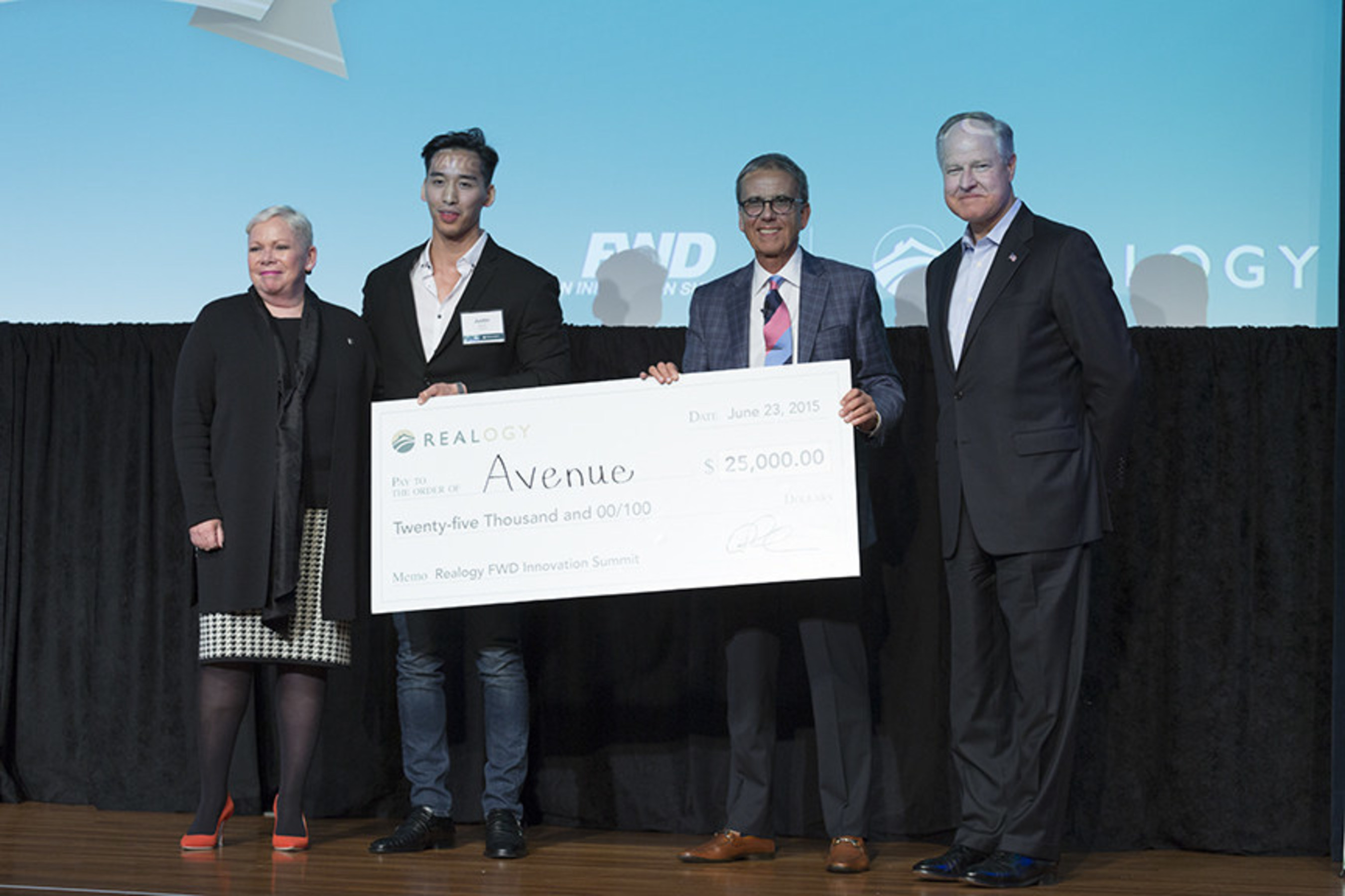 Avenue CEO Justin Shum (second from left) accepts the grand prize at the 2015 Realogy FWD Innovation Summit from Realogy executives (right to left) Richard Smith, Alex Perriello and Sherry Chris.