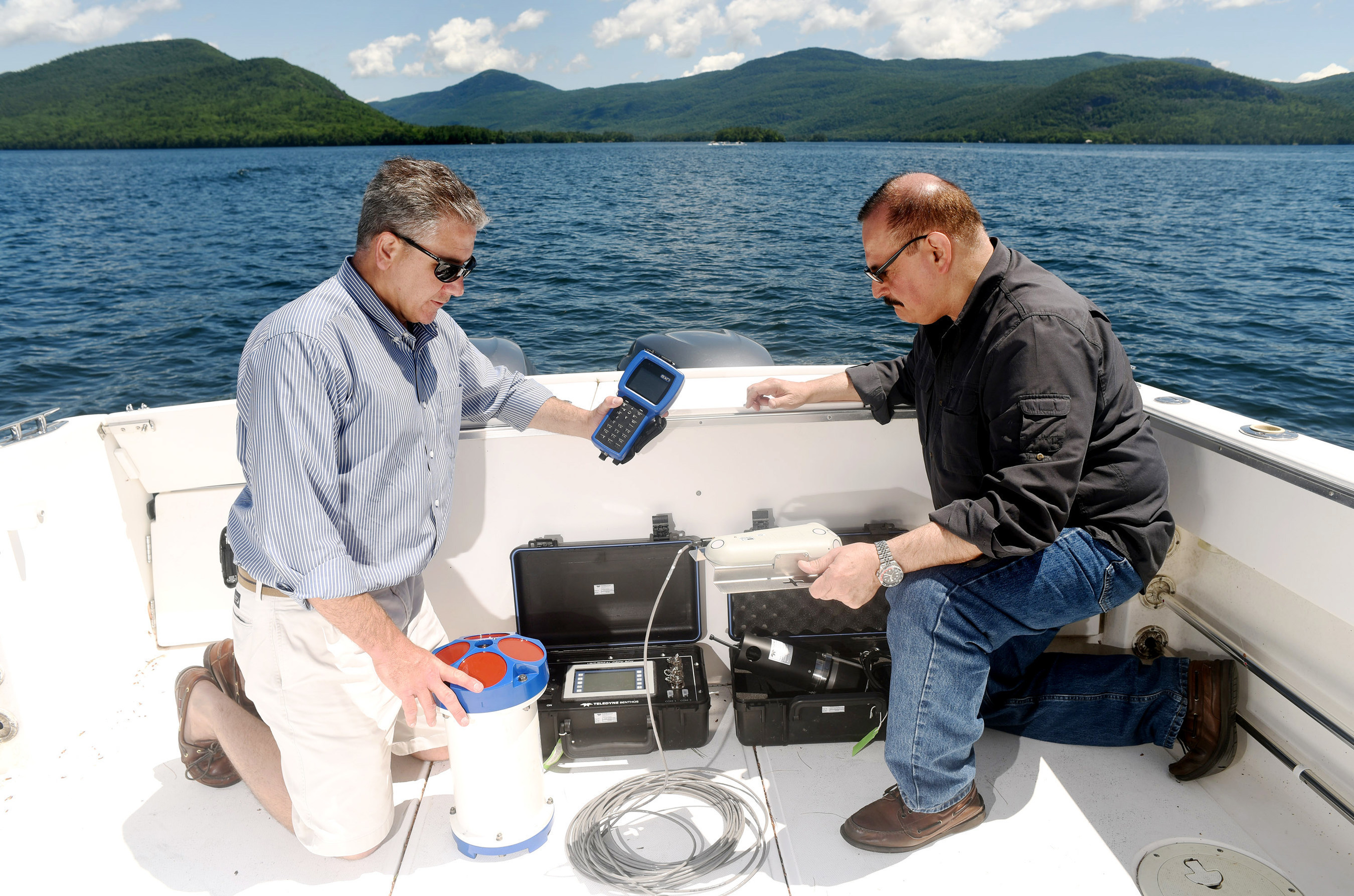 IBM Research scientists Mike Kelly (left) and Harry Kolar (right) deploy an array of sensors that capture data which will be analyzed to help manage and protect New York's Lake George. Their efforts are in support of The Jefferson Project at Lake George, a three year research initiative to deploy Internet of Things technology to create the "world's smartest lake." (Feature Photo for IBM)