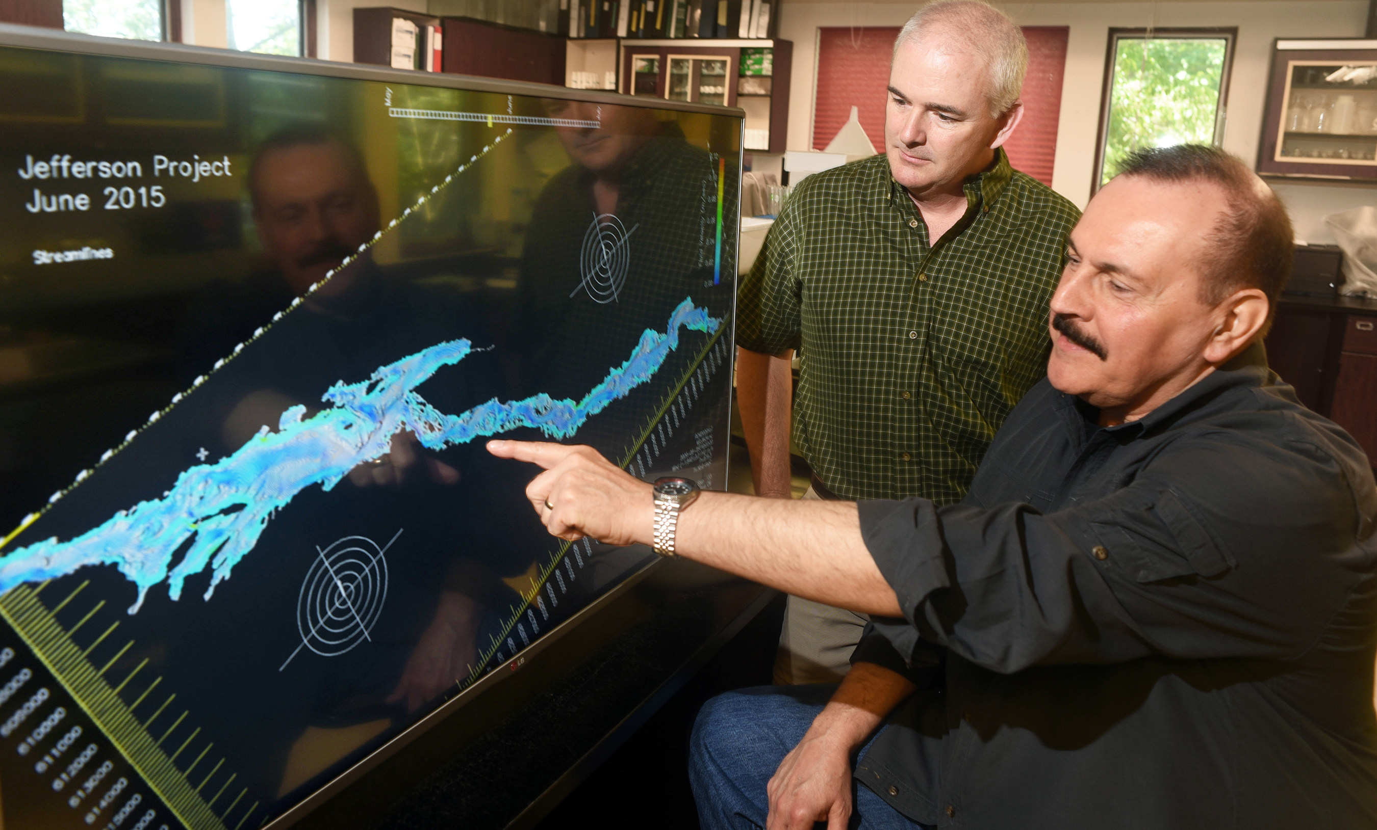 Jefferson Project Director Rick Relyea (left) and IBM Research Distinguished Engineer Harry Kolar (right) examine a visualization of Lake George, as part of The Jefferson Project at Lake George, a three year effort to deploy Internet of Things technology to create the "world's smartest lake." (Feature Photo for IBM)
