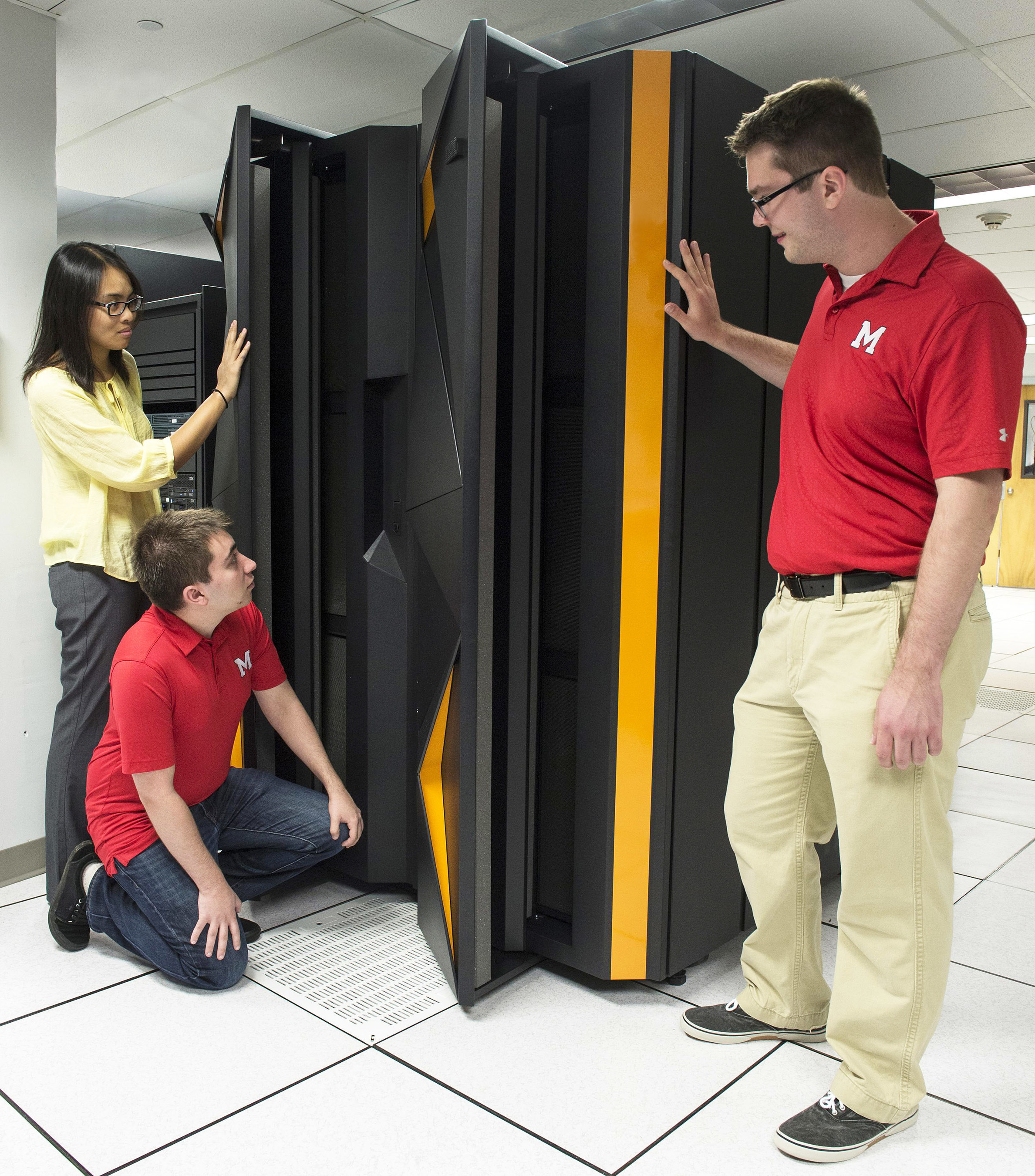 Marist College School of Computer Science & Mathematics students (from left) Paula Batoon, Dominic Rosillo and Charles Hall inspect the school's IBM LinuxONE system. Marist is one of three universities around the world that will host the IBM LinuxONE Developer Cloud, which provides developers access to a virtual IBM LinuxONE at no cost to create and test applications. IBM also is working with academic and corporate partners to host a Master the Mainframe programming contest in 47 countries this year to reach next-generation developers. (Jon Simon/Feature Photo Service for IBM)