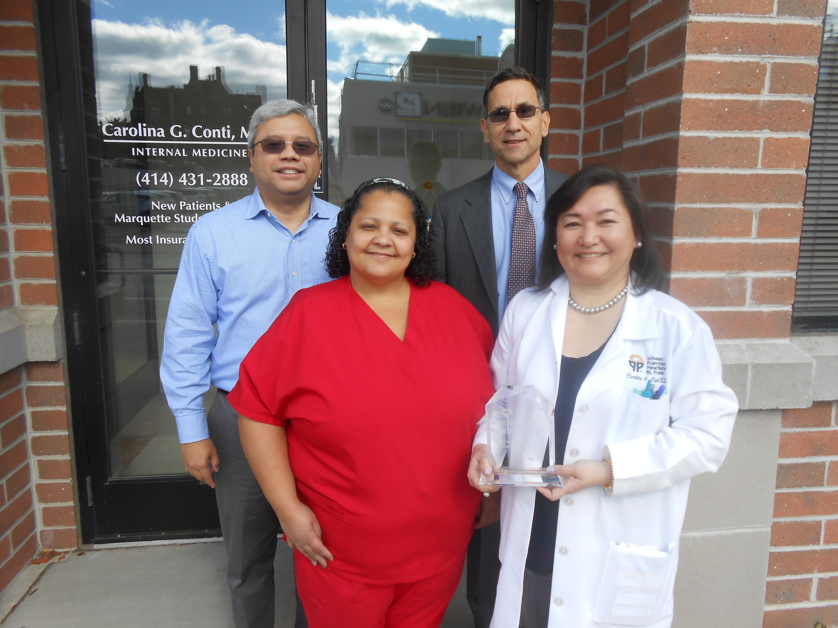 MHS Health Wisconsin presented its 8th Annual Summit Award to Carolina Conti, MD, a board-certified internal medicine physician in Milwaukee, on Oct. 16. From left are Joselito Conti, office manager; Eileen Lozada, medical assistant; Robert Lyon, MD, chief medical officer at MHS Health Wisconsin; and Carolina Conti, MD.