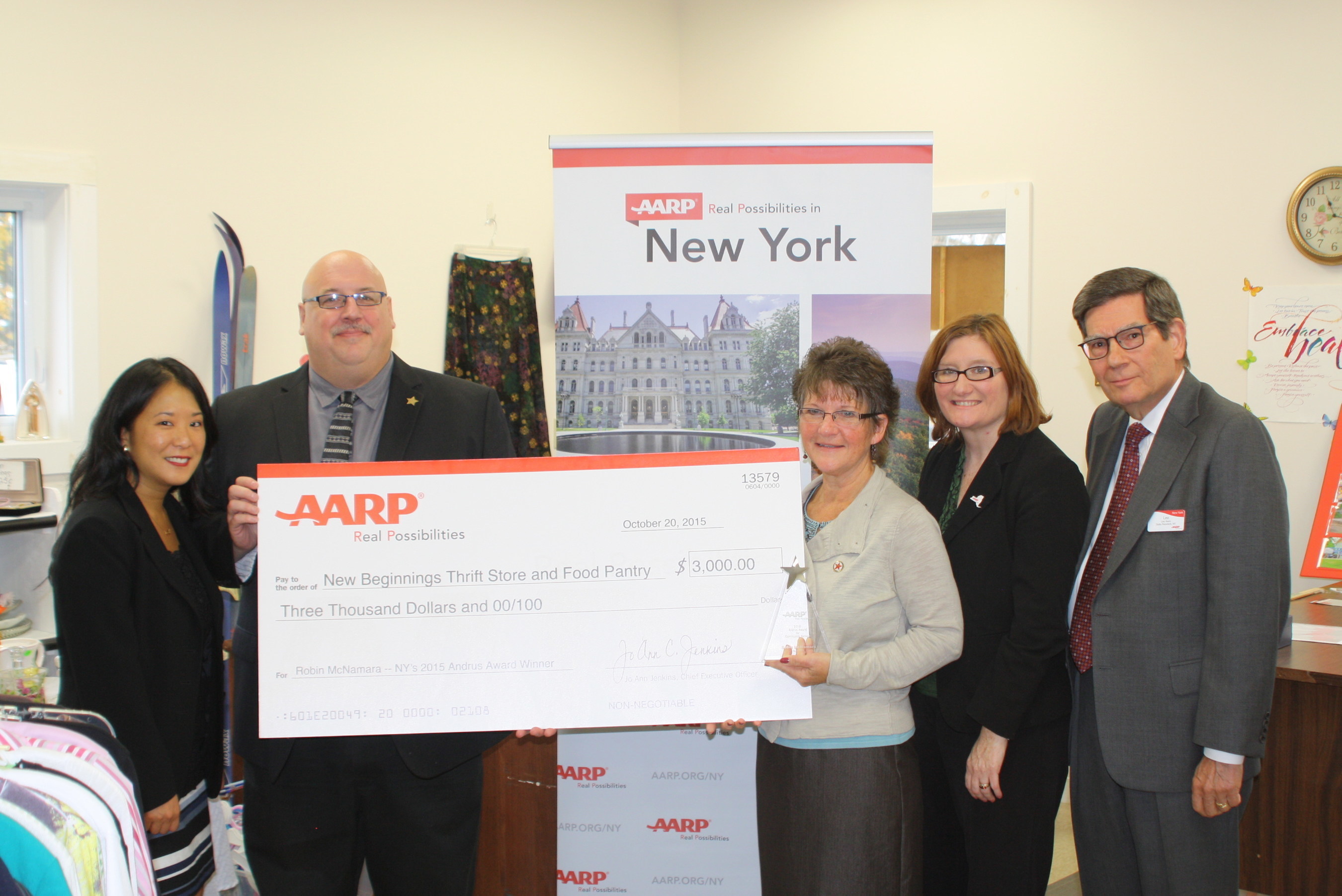 Robin McNamara, third from right, receives $3,000 check from AARP for her selection as the 2015 AARP New York Andrus Award for Community Service recipient. Photo Credit: St. Lawrence Plaindealer
