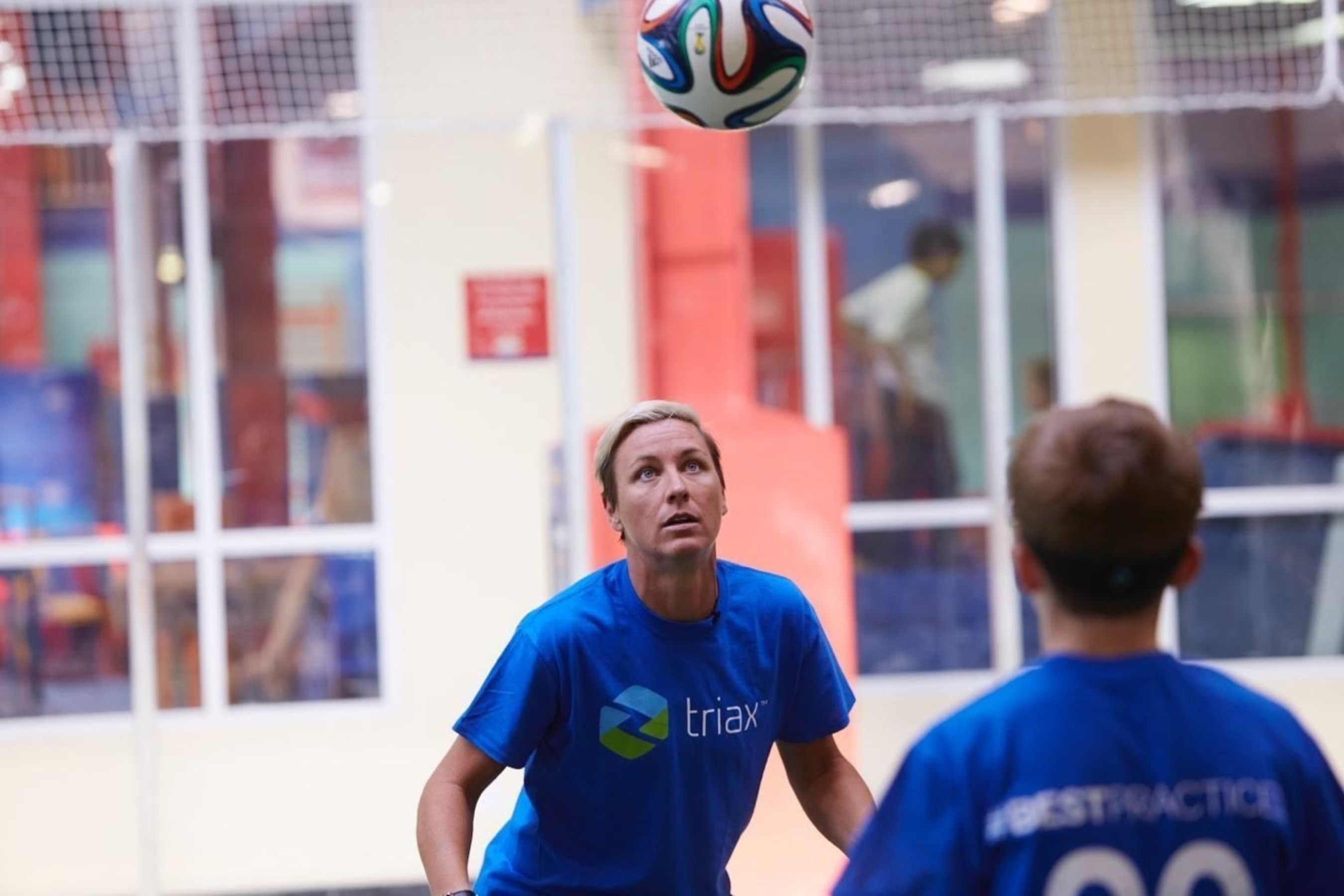 Abby Wambach demonstrates safe heading technique during Triax Tec #BestPractices training session.  Triax today announced partnership with IBM Watson Ecosystem as part of concussion research and safety for players.