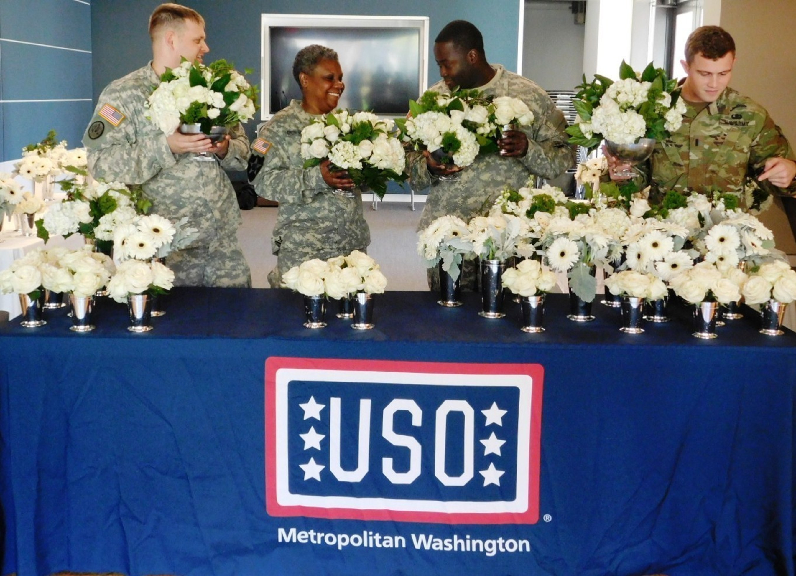 Fresh artisan-designed flowers from premier floral and gifting company FTD help bring a smile to active duty soldiers and their loved ones Wednesday, Oct. 21 at the USO Warrior and Family Center at Bethesda.  FTD honors military service members as part of an ongoing USO campaign encompassing a number of components, including sponsorship of the USO Gala held Oct. 20 and a dedicated USO Collection of bouquets.