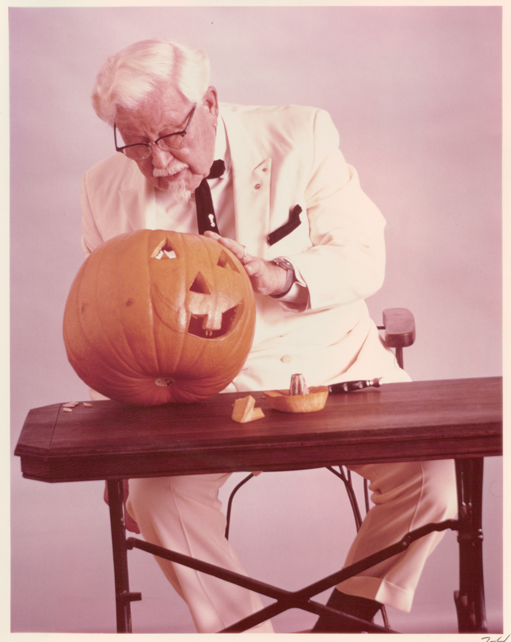 Colonel Sanders carves a Jack-o-lantern