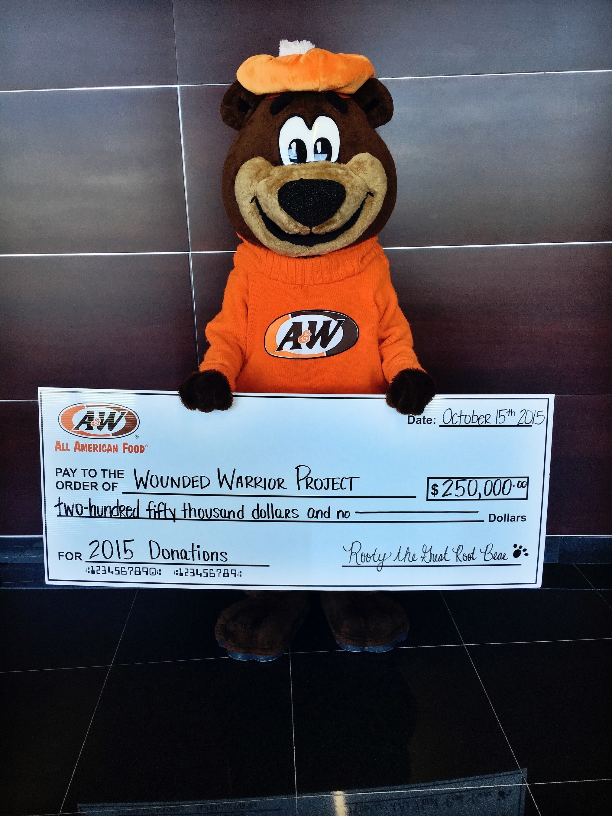 A&W Restaurants' Rootie the Great Root Bear holds a check for $250,000 for the Wounded Warrior Project. Over the last three years, A&W's National Root Beer Float Day promotion has raised $550,000 across its network of 1100 restaurants nationally for the charity.
