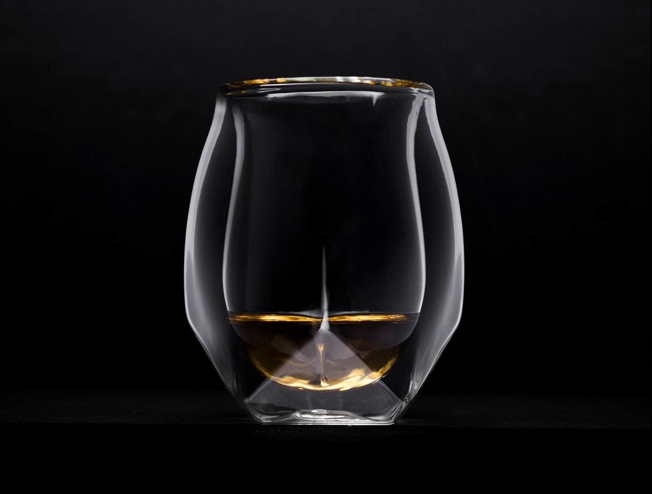 Norlan Whisky Glass - transforms the way whisky is enjoyed through a combination of the advanced aromatic delivery of a snifter with the aesthetic virtues of a tumbler. The glass is to be the flagship release in an evolving suite of products dedicated to modernizing the whisky drinking experience.