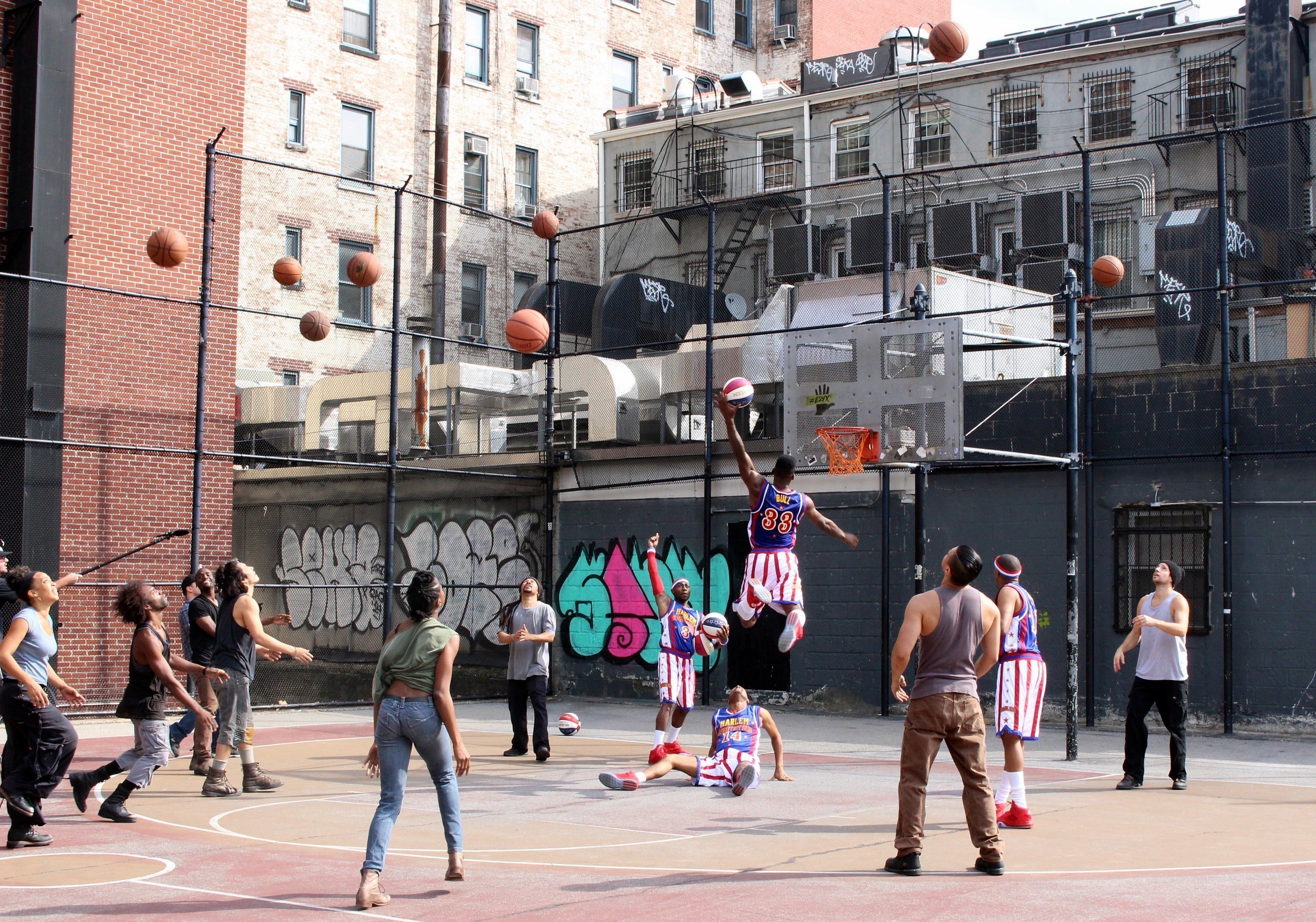The Harlem Globetrotters and the group STOMP took to an outdoor basketball court in New York City's Greenwich Village to celebrate the Globetrotters' 90th year.