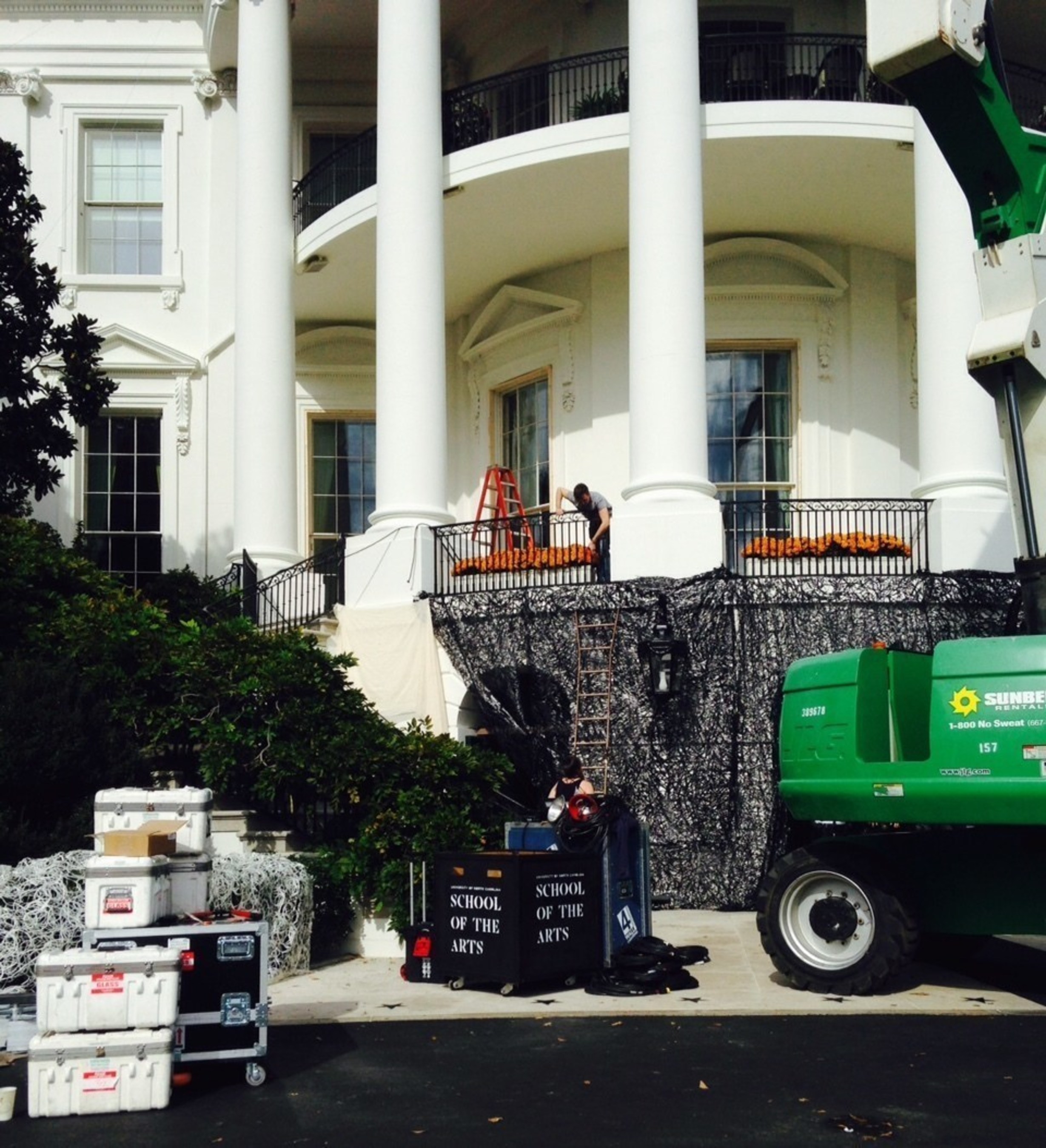 Students, faculty and alumni from the University of North Carolina School of the Arts in Winston-Salem install equipment on the South Portico of the White House in preparation for the annual trick or treat event