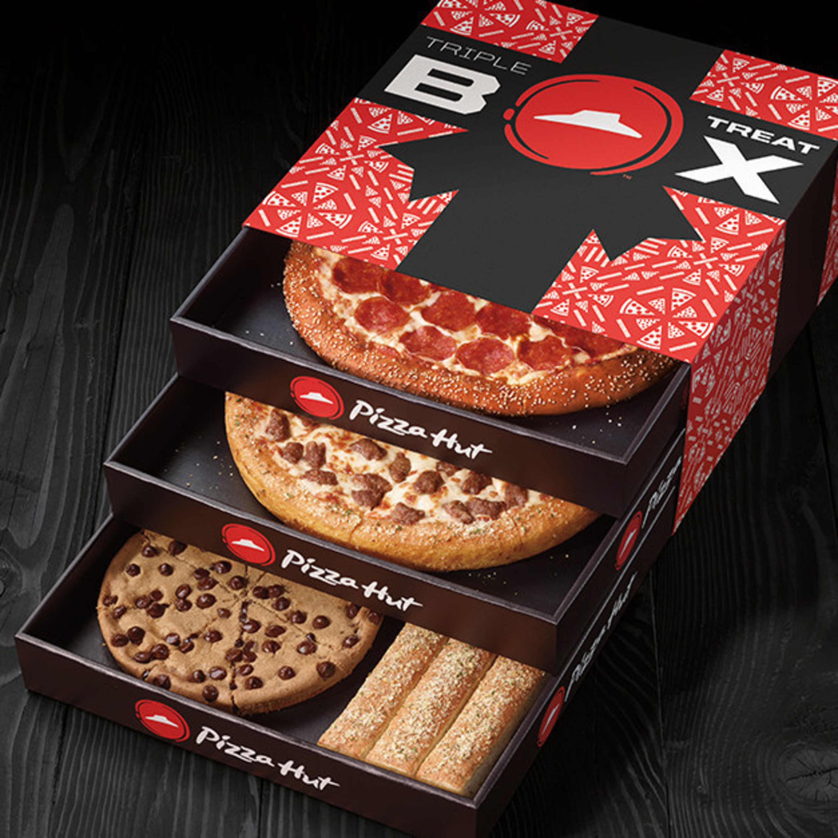 Starting today, pizza lovers everywhere will have a new item to add to their holiday wish lists: Pizza Hut's new Triple Treat Box, a uniquely-packaged pizza "box" that features pizzas, desserts, sides and more. Available while supplies last, the tri-level, holiday-themed Triple Treat Box includes two medium one-topping pizzas (available on Hand Tossed, Thin N' Crispy(R) or Pan), an order of breadsticks or flavor sticks and a Hershey's Ultimate Chocolate Chip Cookie, all for just $19.99.