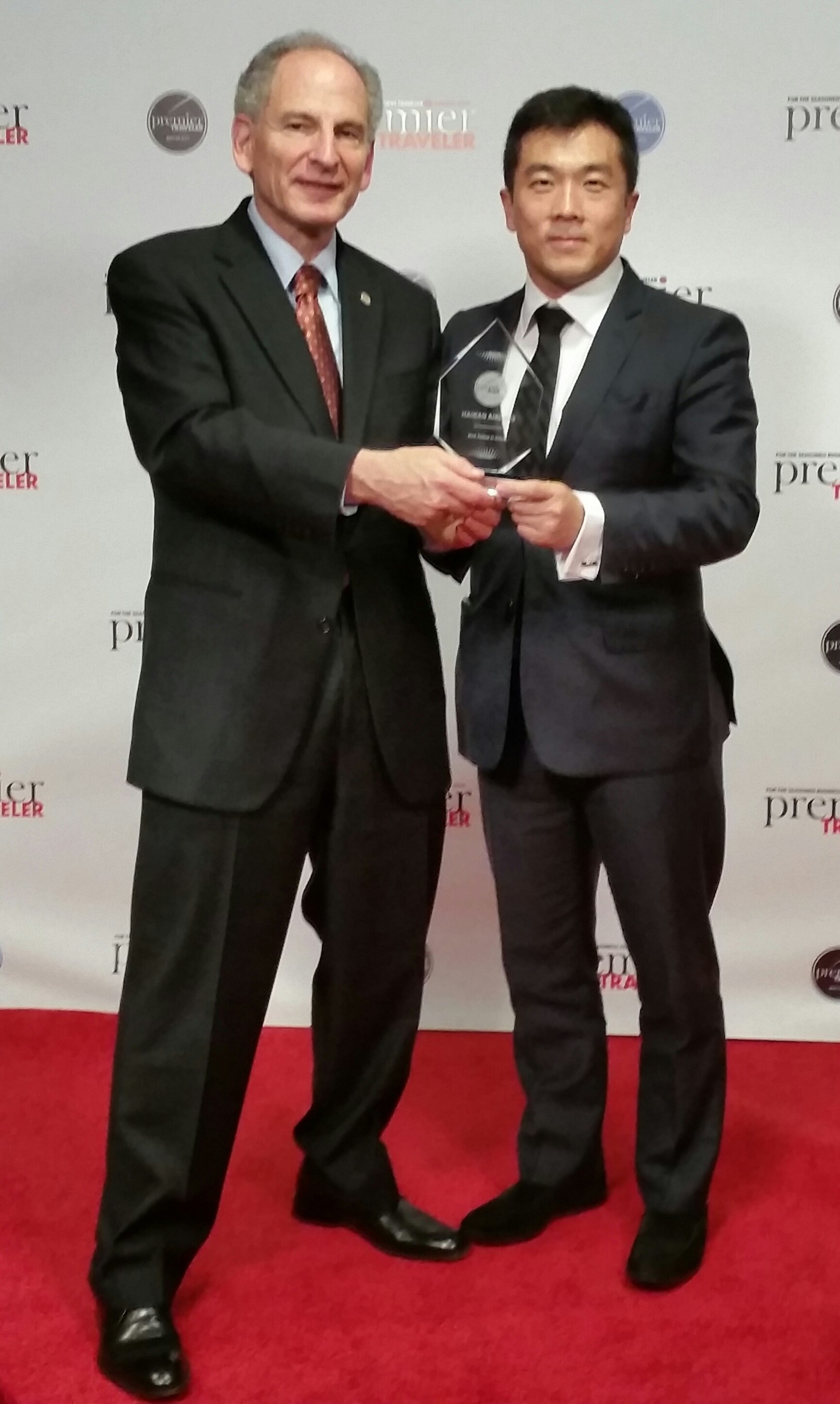 Hainan Airlines U.S. Executive Director Joel Chusid and North American Managing Director Pubin Liang accept the Premier Traveler award for Best Airline in China.