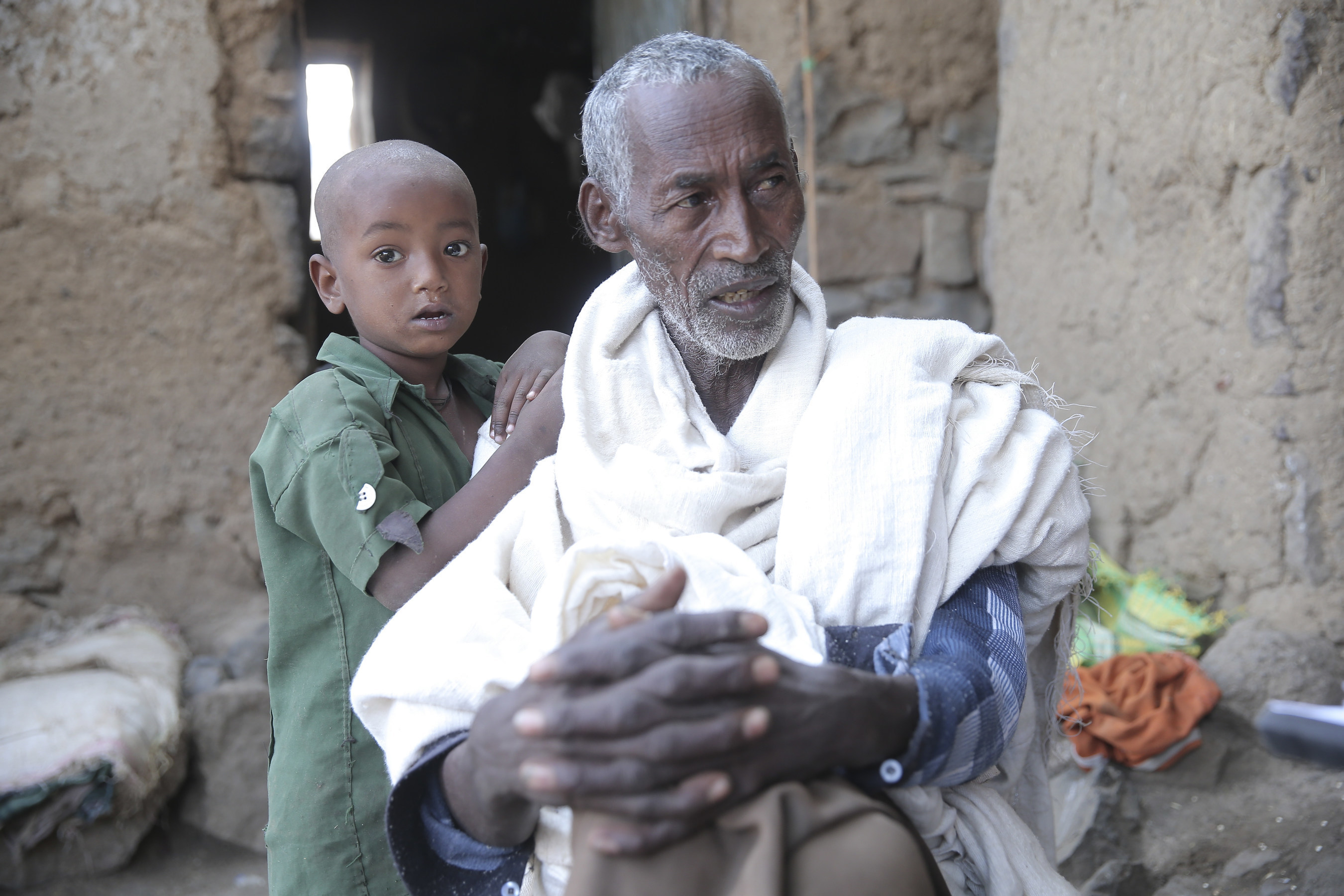 Birhanu, 73, lives in the Amhara Region of Ethiopia. He is married with eight kids. He is a farmer who produces millet and teff. Due to the drought, he has not harvested for some time, and in addition, two of his oxen have died and he was obliged to sell three others. Now he has only one ox and a calf, as well as eight sheep, which are in good condition. The millet farm is completely destroyed and doesn't even have seeds for the next cultivation.