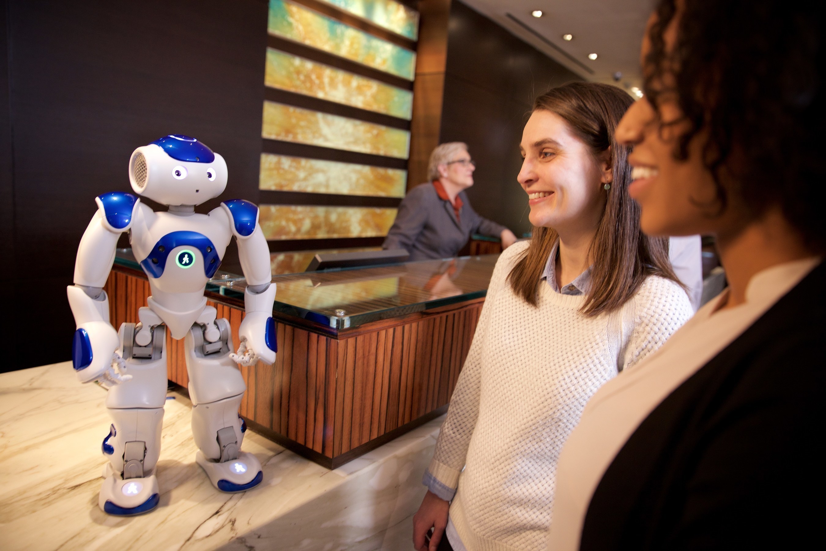 Visitors to the Hilton Hotel in McLean, Va. meet "Connie," a robot concierge named after Conrad Hilton and powered by IBM Watson and WayBlazer. Connie, in pilot testing at the hotel, uses cognitive computing and machine learning to answer questions posed in natural language about the hotel, local tourist attractions and restaurants -- while learning with each interaction. (Photo courtesy of Green Buzz Agency/Feature Photo Service for IBM)