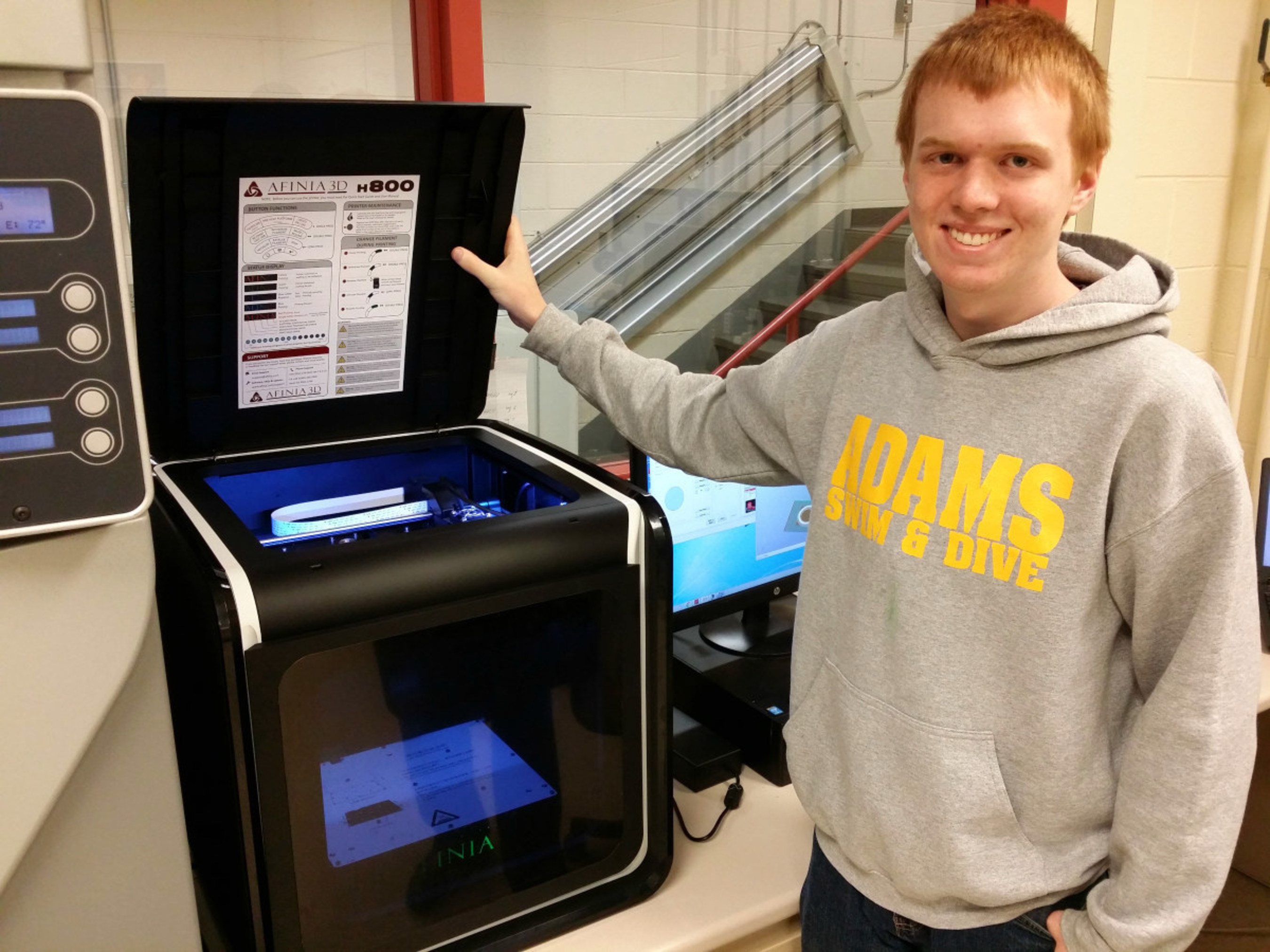 Daniel Alspach, a student at Oakland Schools Technical Campus Northeast in Pontiac, Michigan, works with the Afinia 3D printer given by SME