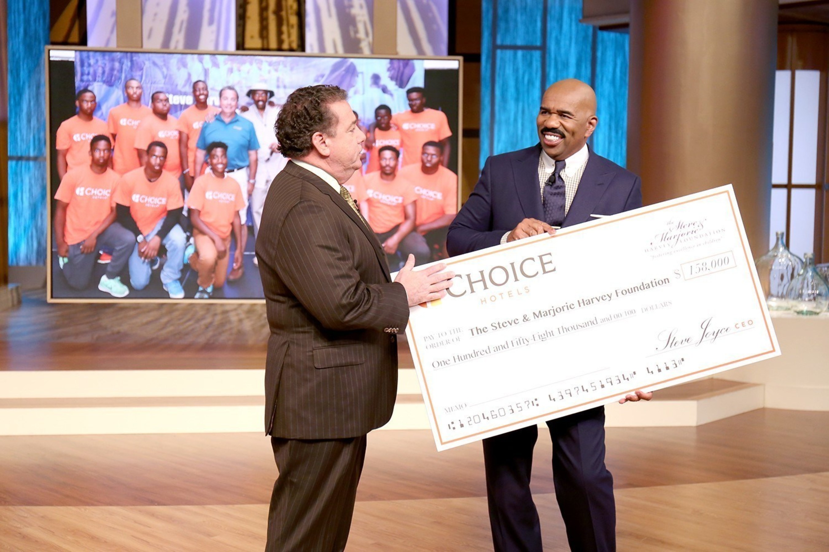 Choice Hotels President and CEO presents donation for the Steve & Marjorie Harvey Foundation