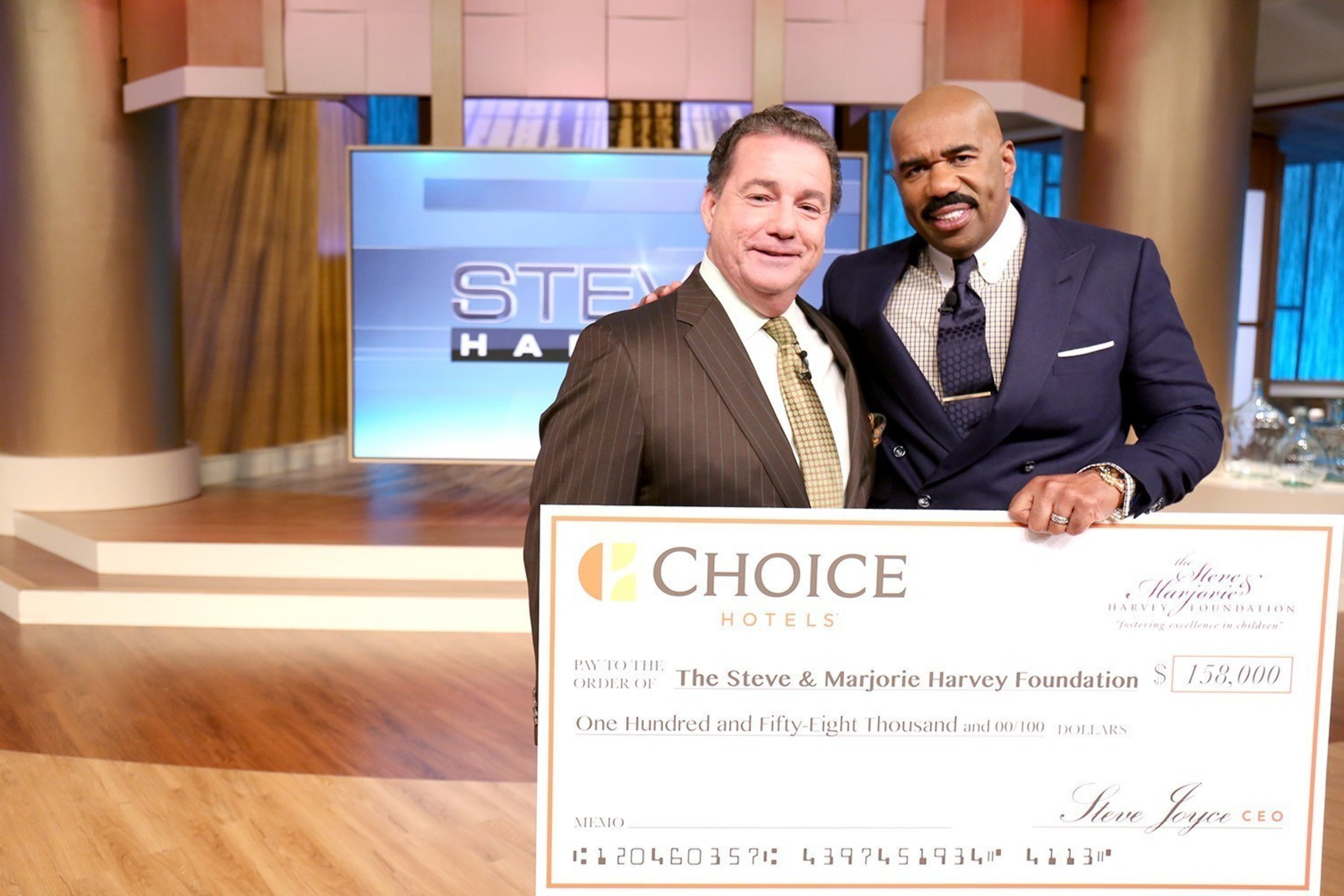 Choice Hotels President and CEO presents donation for the Steve & Marjorie Harvey Foundation