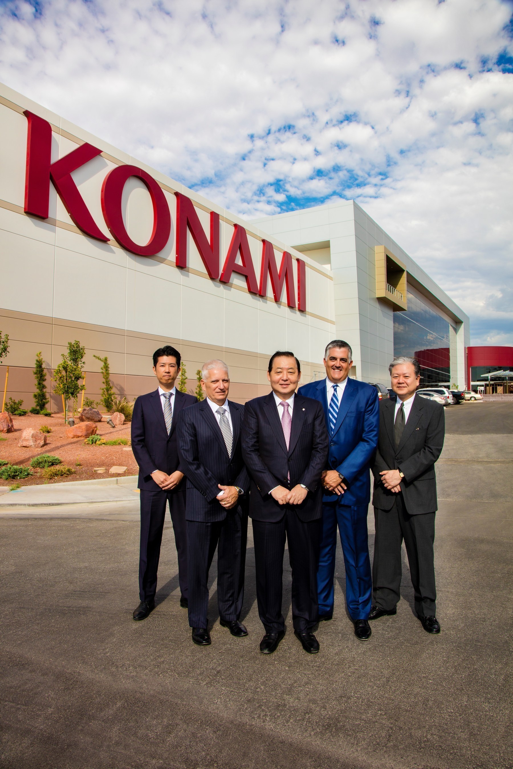 Konami Gaming, Inc.'s executive leadership team stands alongside the completed expansion of its Las Vegas headquarters