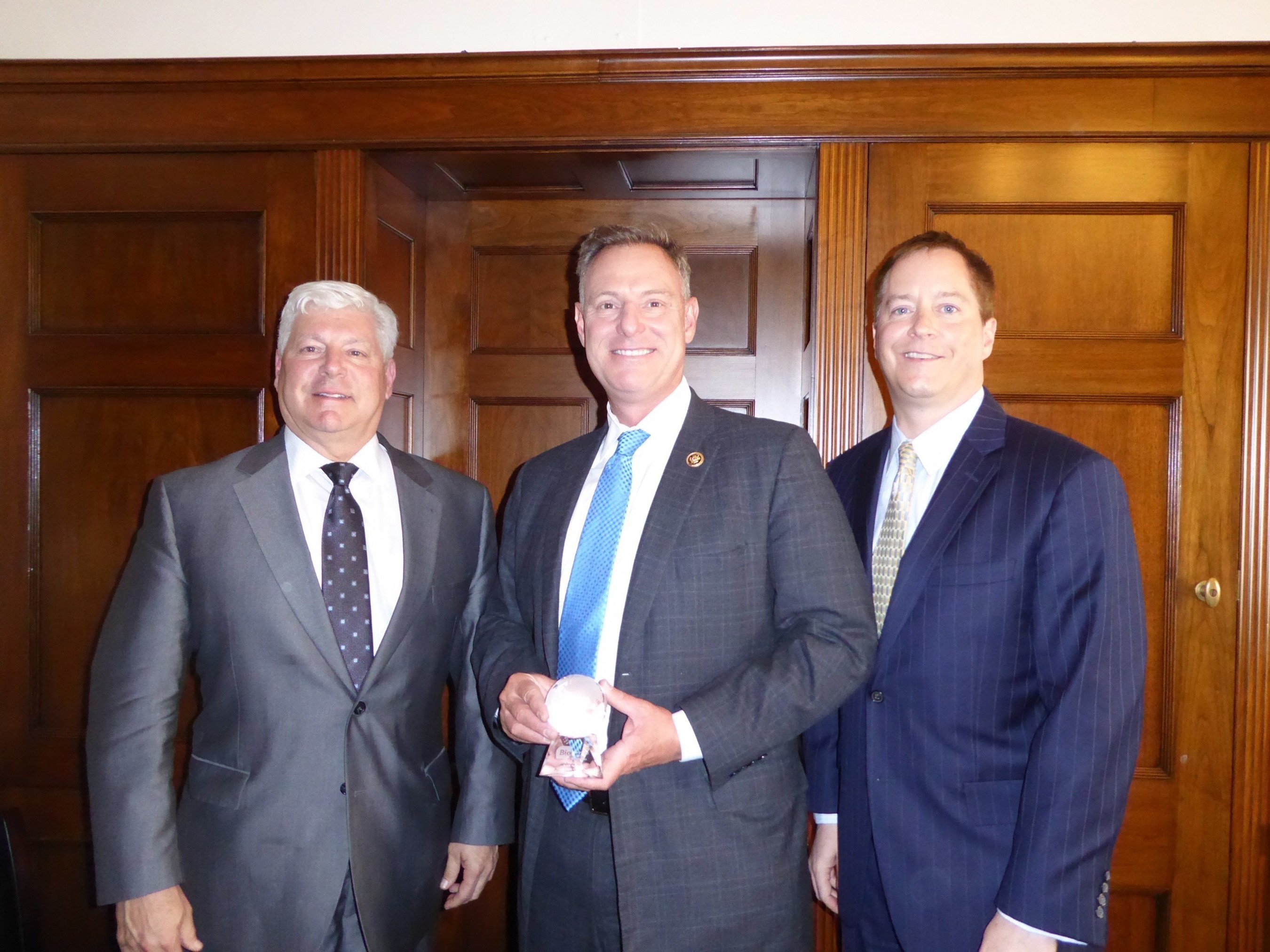 Congressman Scott Peters (center) receives the 2016 BIO Legislator of the Year Award. Joe Panetta (left), president and CEO of Biocom, and Todd Gillenwater, (right) executive vice president of CLSA, are pictured with Representative Peters.