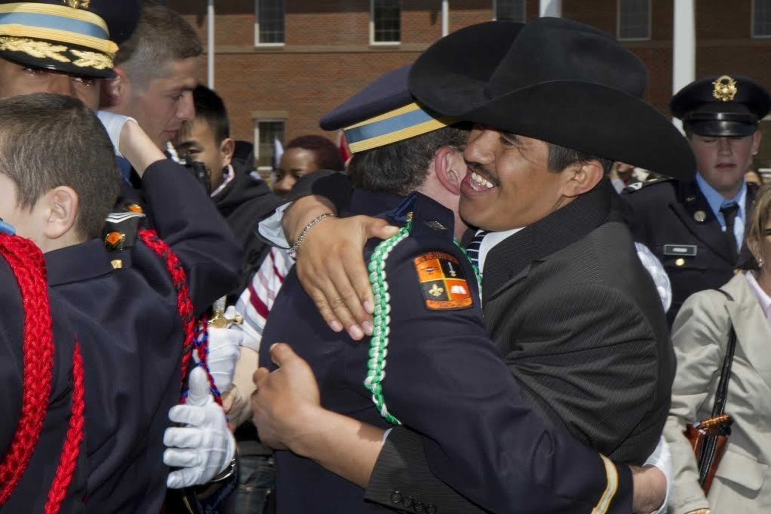 Leo Alvarado, Spanish teacher and soccer coach at St. John's Military School in Salina, Kansas, hugs a graduate and former student at Commencement. Teachers and staff at St. John's place a strong emphasis on building relationships with cadets and their families. St. John's was recently recognized for placing a strong emphasis on engaging families in their child's education and social development as well as the school's commitment to ensuring each cadet is supported by at least one adult advocate. Many former students stay in touch with their teachers and "St. John's Moms" long after graduation.