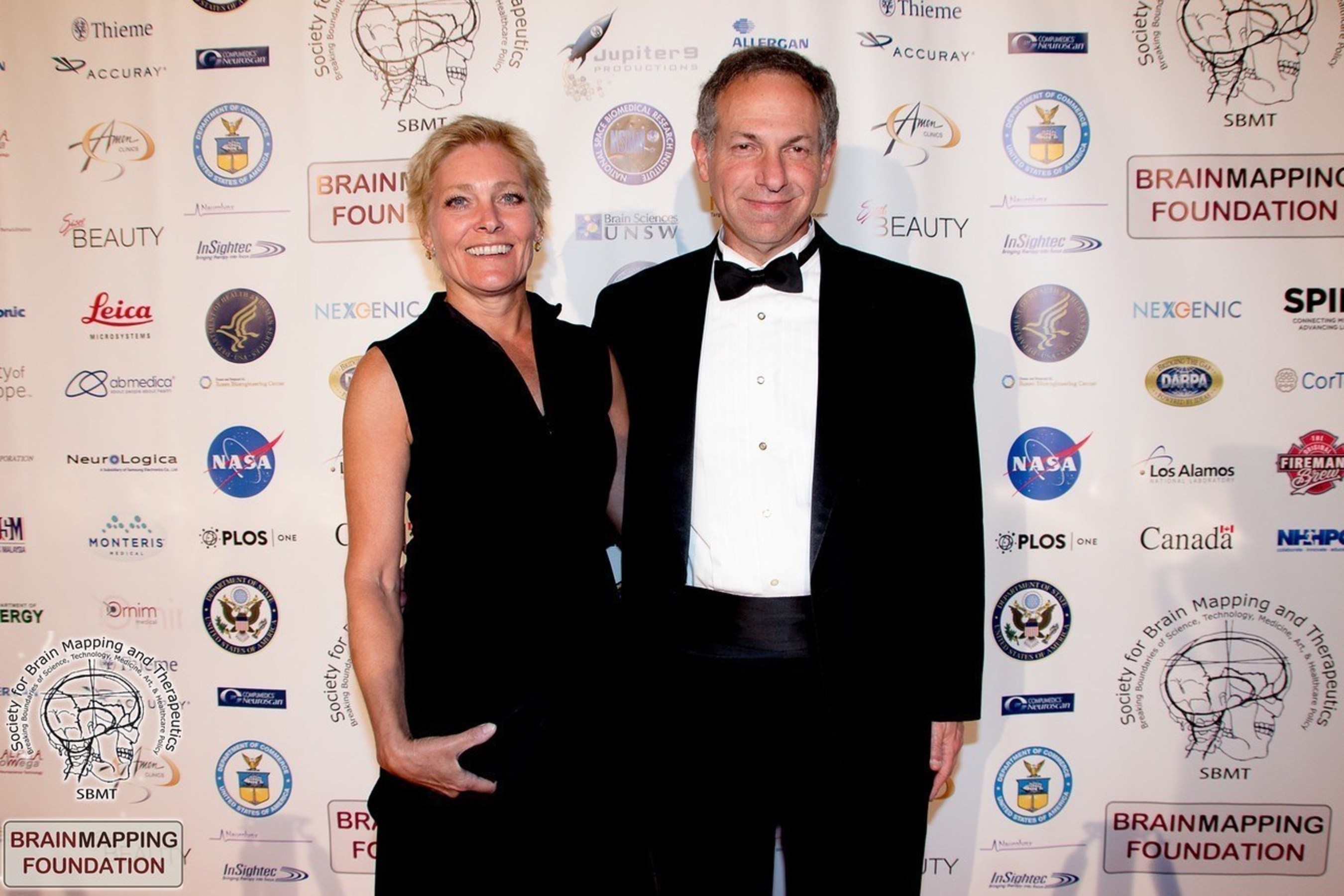 Former Lt. Colonel US Army Reserve, Aaron G. Filler, MD, PhD, FRCS, JD and his wife former Captain, US Air Force, Annelise Shaw. Dr Filler - awardee of the Pioneer in Medicine Award of the Society for Brain Mapping & Therapeutics (SBMT), is currently President and Counsel for SBMT. He is the lead inventor of Diffusion Tensor Imaging (DTI) the method that visualizes human brain tracts to detect brain injury in impact sports, accidents, and in war fighters in the field.