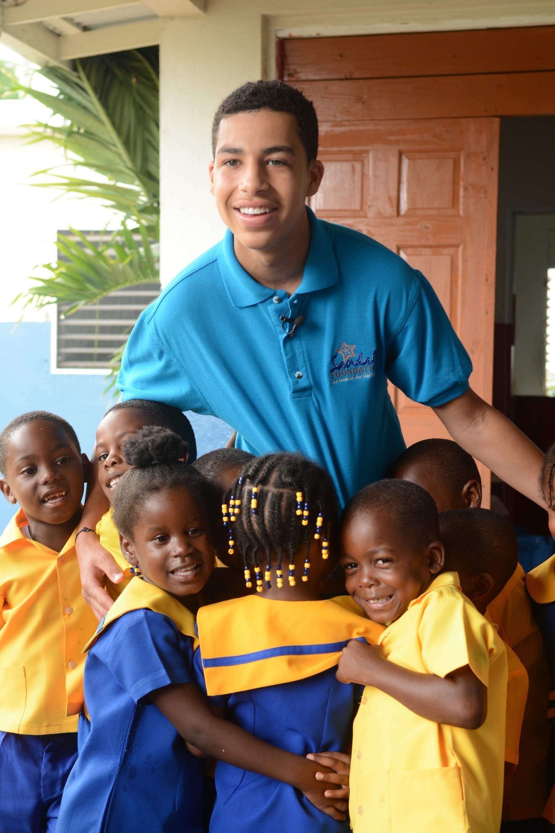 Caption: Sandals Foundation's Youth Advocate Ambassador, Marcus Scribner gets a warm welcome from the students at Seville Golden Preschool in Ocho Rios, Jamaica. This visit was part of his trip to Beaches Ocho Rios A Spa, Golf & Waterpark ResortCREDIT: Beaches Resorts