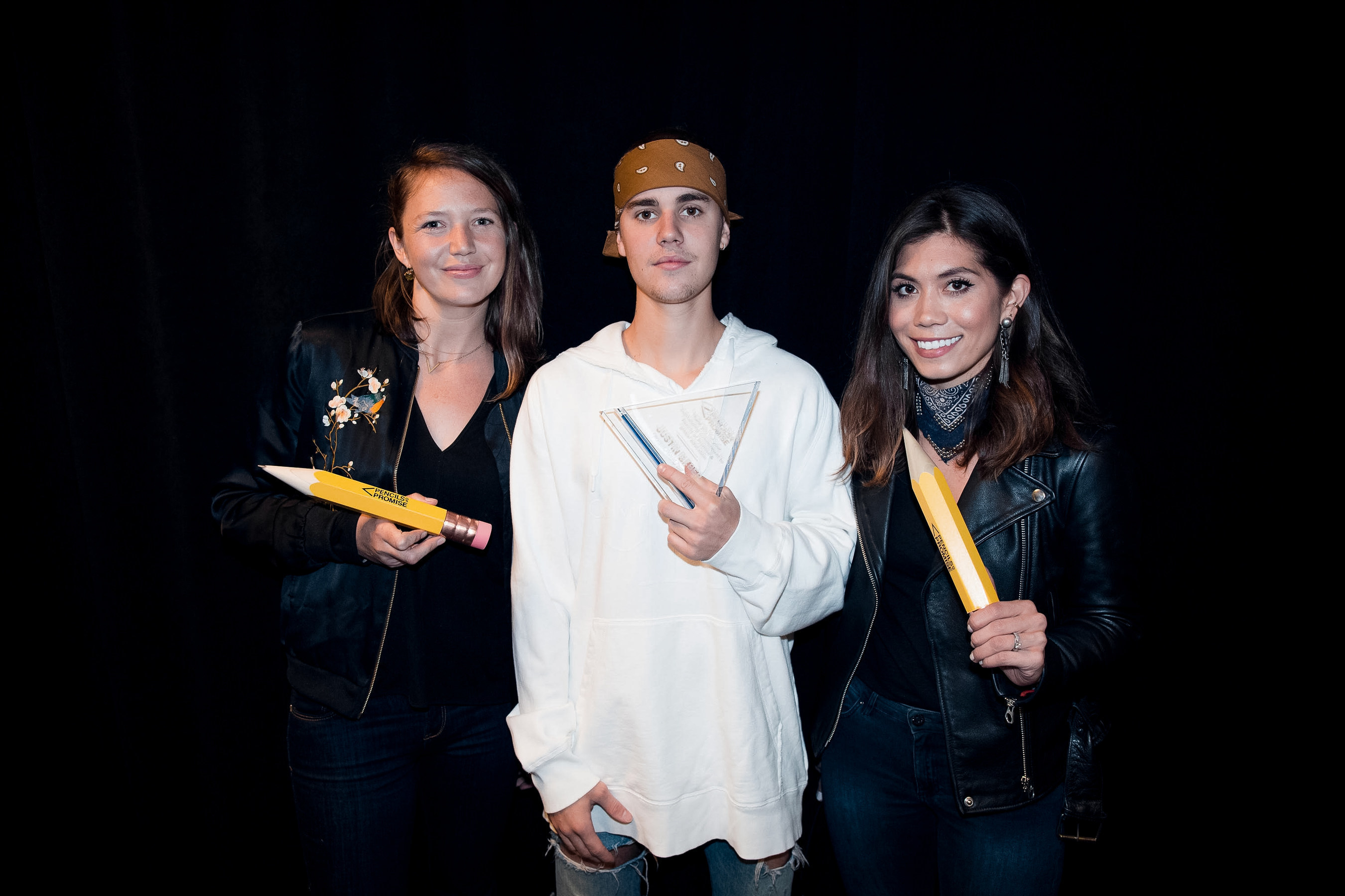Pencils of Promise executives Leslie Engle Young (L) and Natalie Ebel (R) present Justin Bieber with the first-ever Pencils of Promise Global Ambassador award just prior to his sold out show at the Barclays Center in Brooklyn, New York on May 4. (Credit: Rory Kramer)