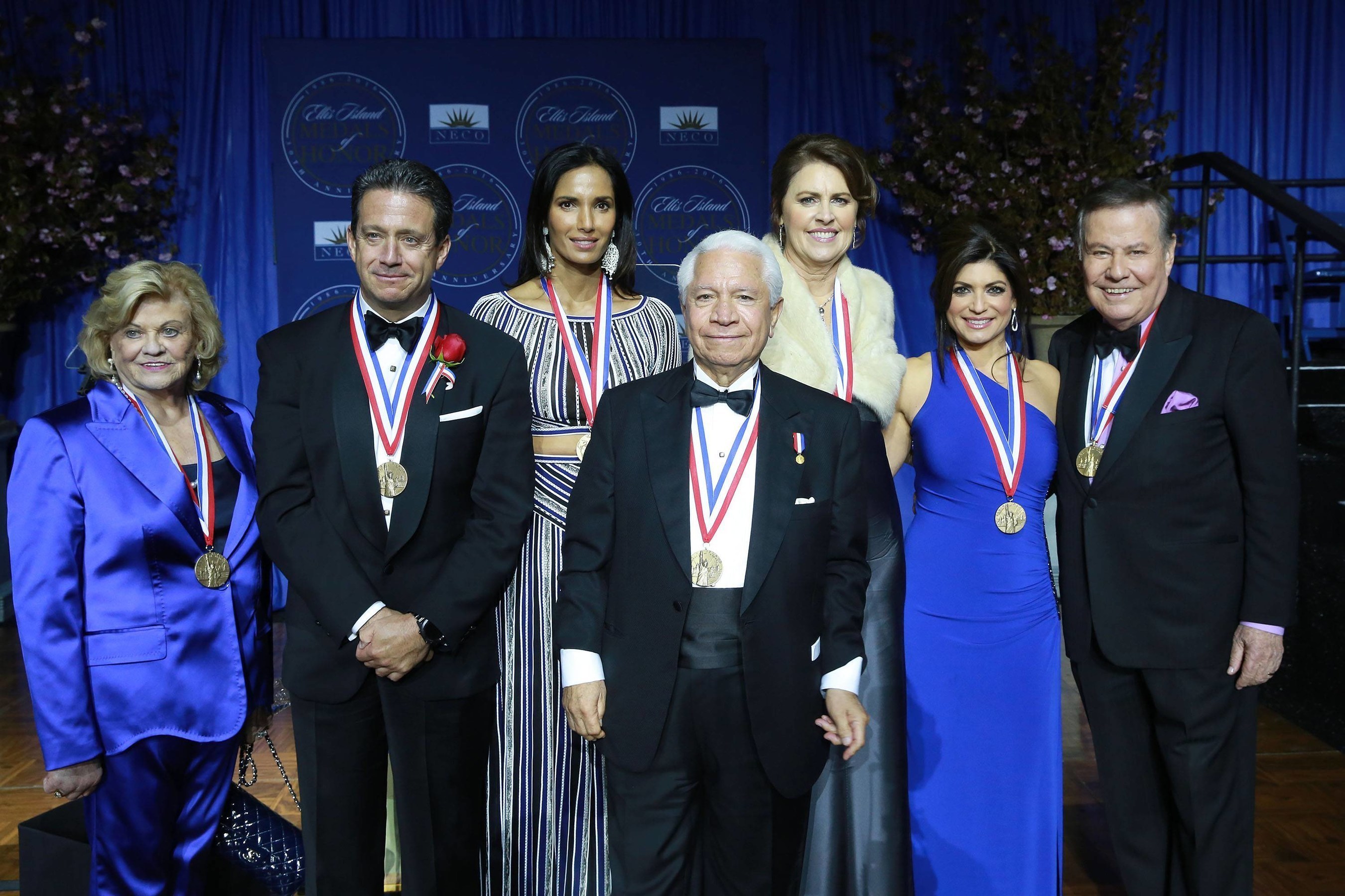 Photo Caption (left to right): Lorraine Thomas, philanthropist and co-founder of The Dave Thomas Foundation for Adoption, Bill Evans, meteorologist WABC-TV, Padma Lakshmi, TV host, Nasser J. Kazeminy, Chairman of the National Ethnic Coalition of Organizations-NECO, Ali Torre, co-founder of the Joe Torre Safe At Home Foundation, Tamsen Fadal, News Anchor WPIX-TV and Marvin Scott, Senior Correspondent WPIX-TV attend the National Ethnic Coalition of Organization's 2016 Ellis Island Medals of Honor awards ceremony on Ellis Island. (Photo by Amy Sussman AP Images)