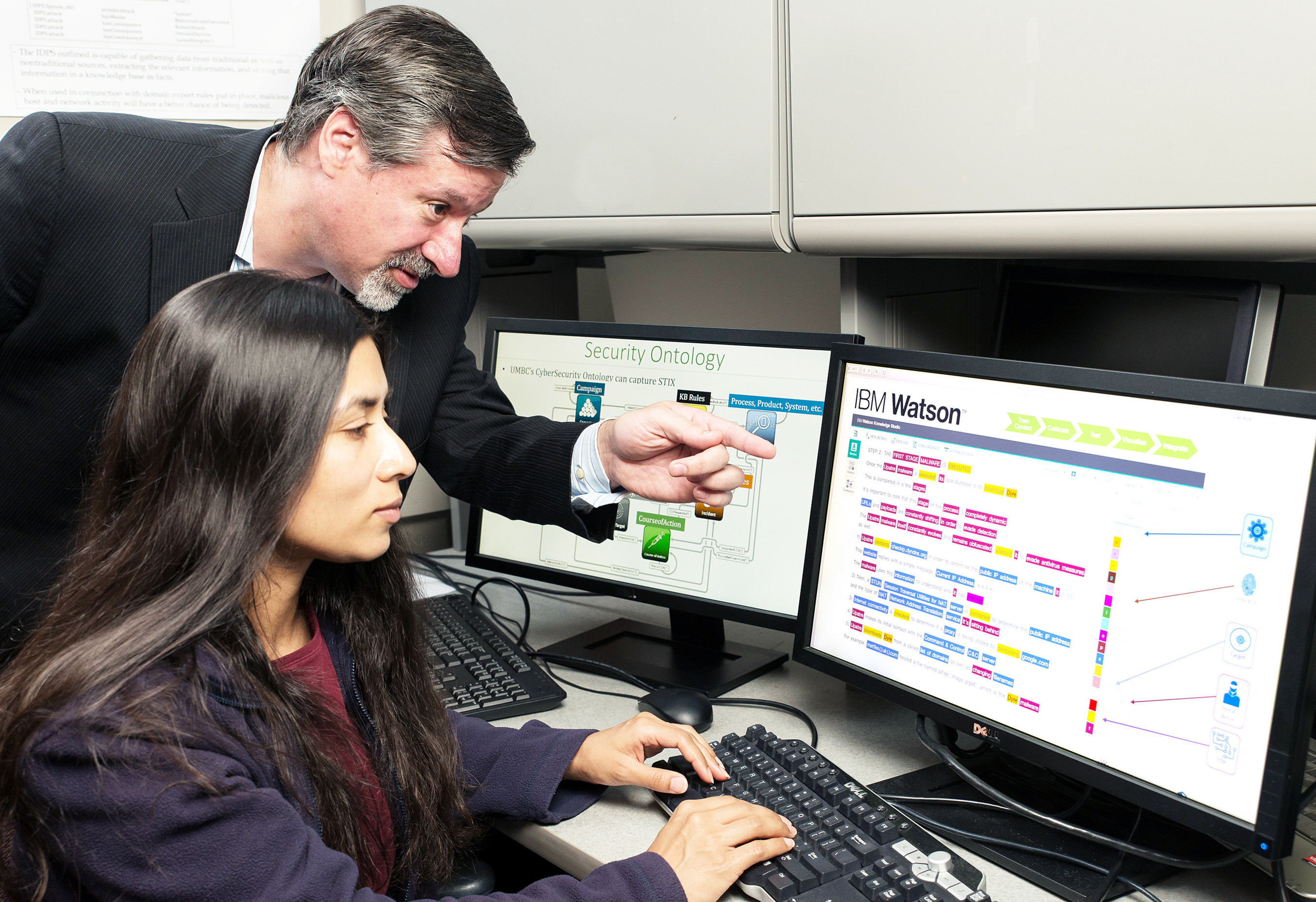 IBM's Chief Watson Security Architect Jeb Linton demonstrating to University of Maryland Baltimore County student Lisa Mathews how to teach IBM's Watson the language of security, Tuesday, May 10, 2016, Baltimore, MD. IBM will work with 8 universities to train Watson for Cyber Security, so that the next generation of security professionals can leverage the power of "cognitive" technology to defend against cyberattacks.  (Mitro Hood/Feature Photo Service for IBM)