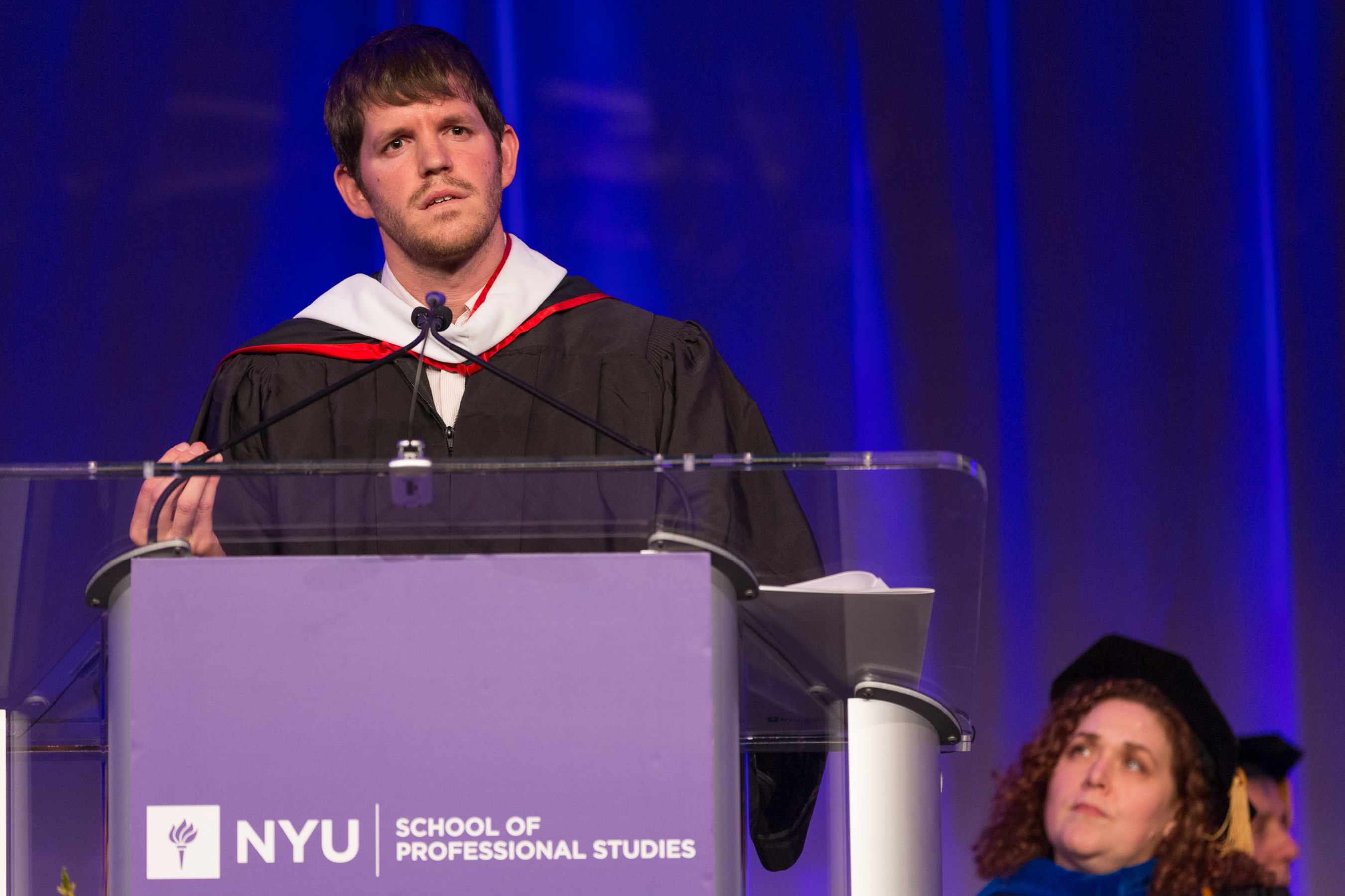 Acclaimed Photographer & Founder of Humans Of New York, Brandon Stanton, delivered a stirring speech to graduates of the NYU School of Professional Studies (NYUSPS), who received their degrees at the Undergraduate Convocation ceremony on May 15 at the Grand Hyatt New York. He reminded students that time is the most valuable resource in the world, and it should not be squandered. Instead, he urged them not to wait for their idea or plan to be perfect, but to take the step now to pursue their dreams. Photo Credit: NYUSPS/Mark McQueen