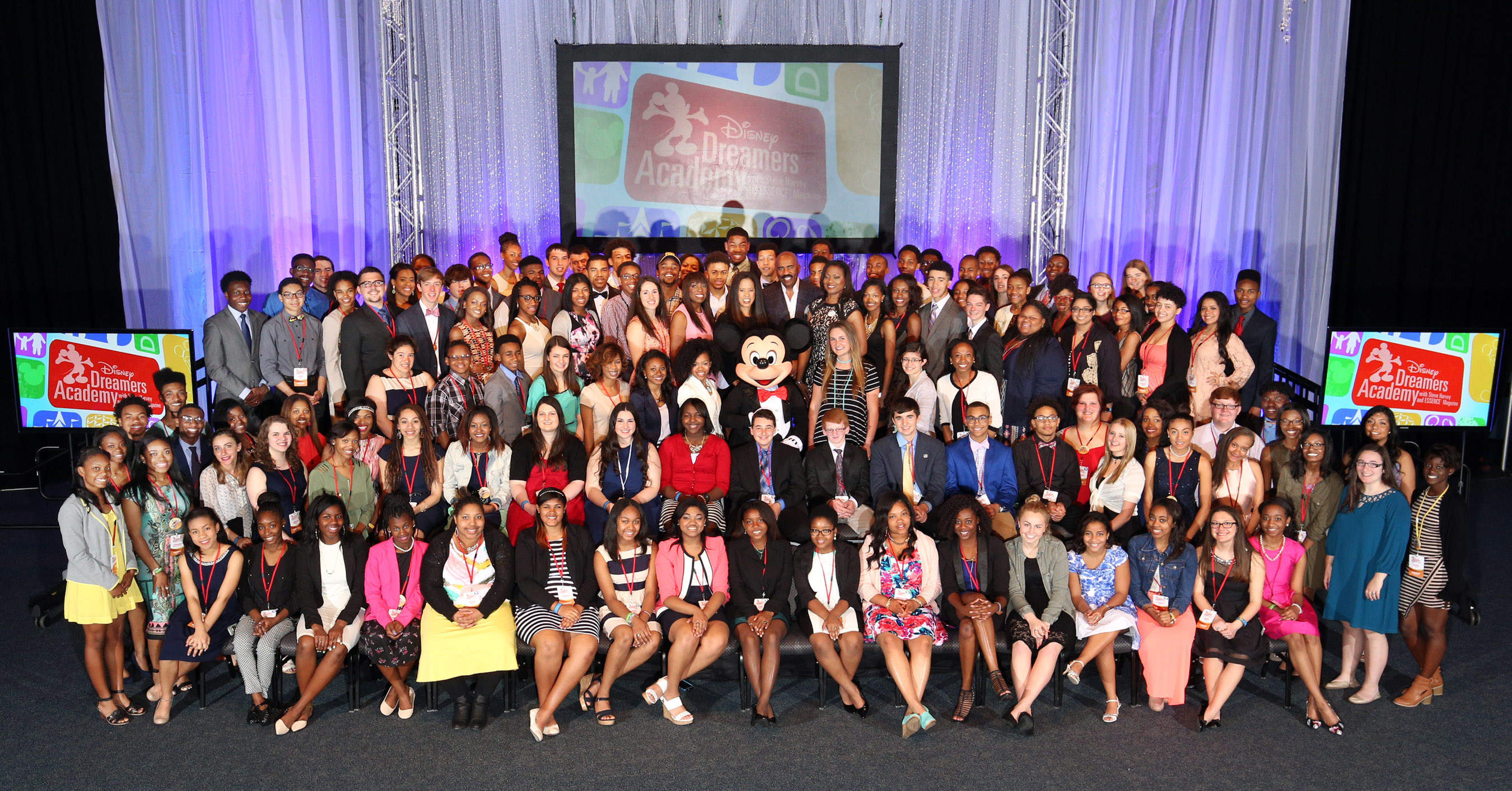 Disney Dreamers Academy Class of 2016 Disney Dreamers join (behind Mickey Mouse L-R) Mikki Taylor, editor-at-large for Essence Magazine, Michelle Ebanks, president of Essence Communications, Inc., radio and TV personality Steve Harvey, Tracey D. Powell, executive champion of Disney Dreamers Academy, and Mickey Mouse on March 6, 2016 to celebrate the commencement of the ninth Disney Dreamers Academy with Steve Harvey and Essence Magazine at Walt Disney World Resort in Lake Buena Vista, Fla. The annual...