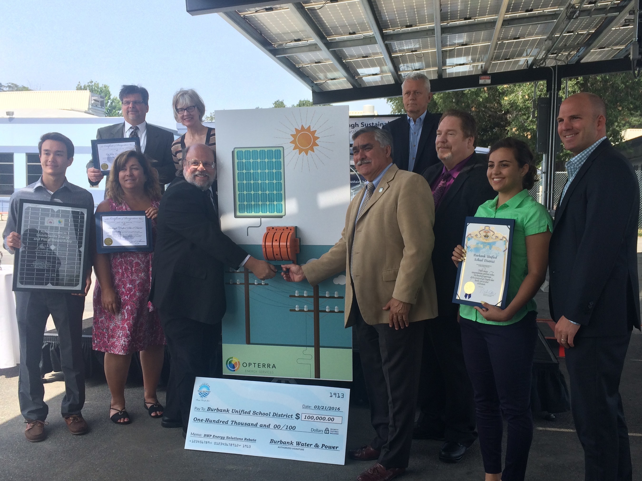 Members of the Burbank community, including the Board of Education President Larry Applebaum, Mayor Jess Talamantes, Superintendent Matt Hill, and OpTerra Energy Services partners and student interns "flip the switch" on renewable energy at the Burbank Adult School.